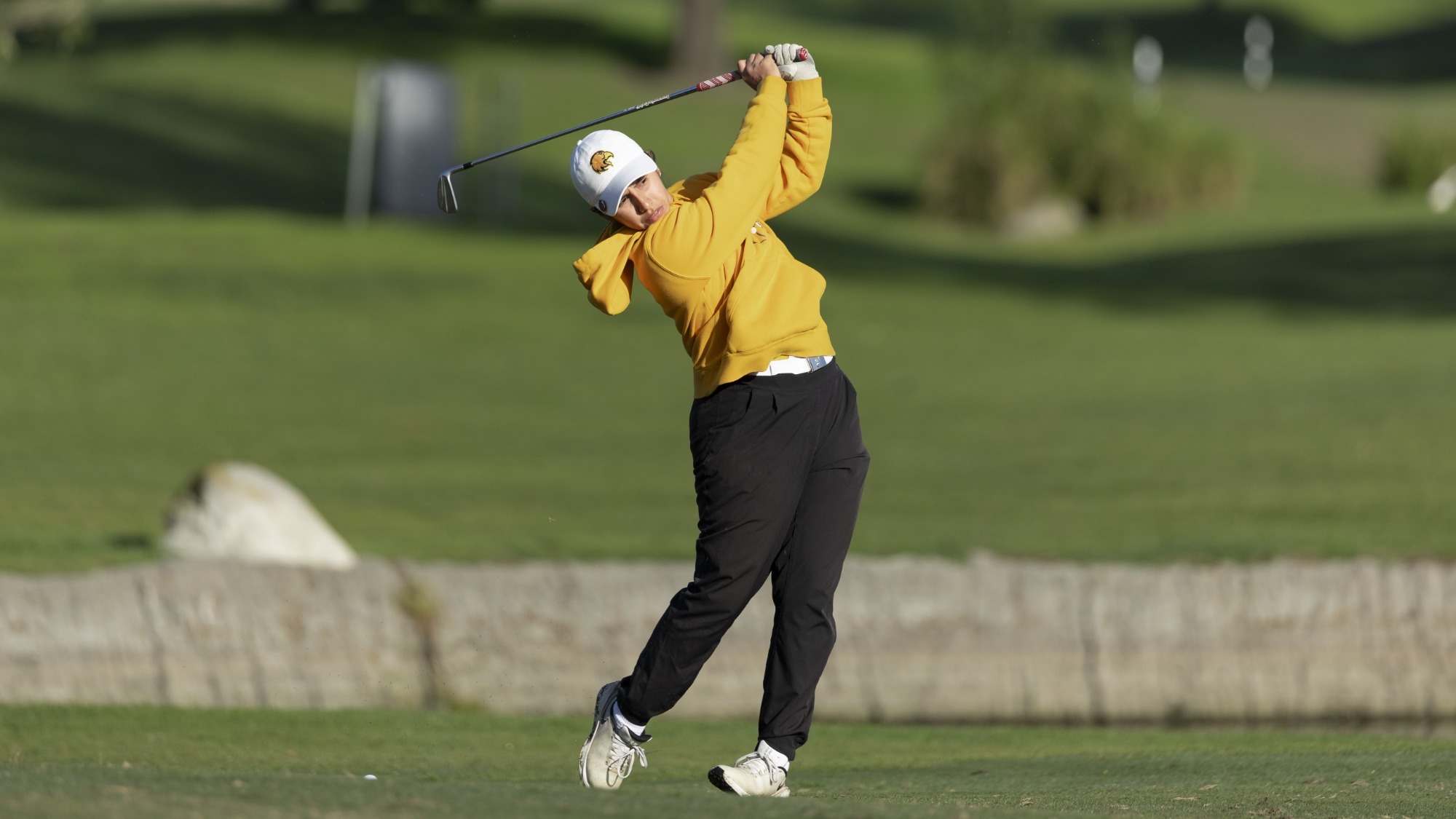 daniela andrade follows through with a shot from the fairway