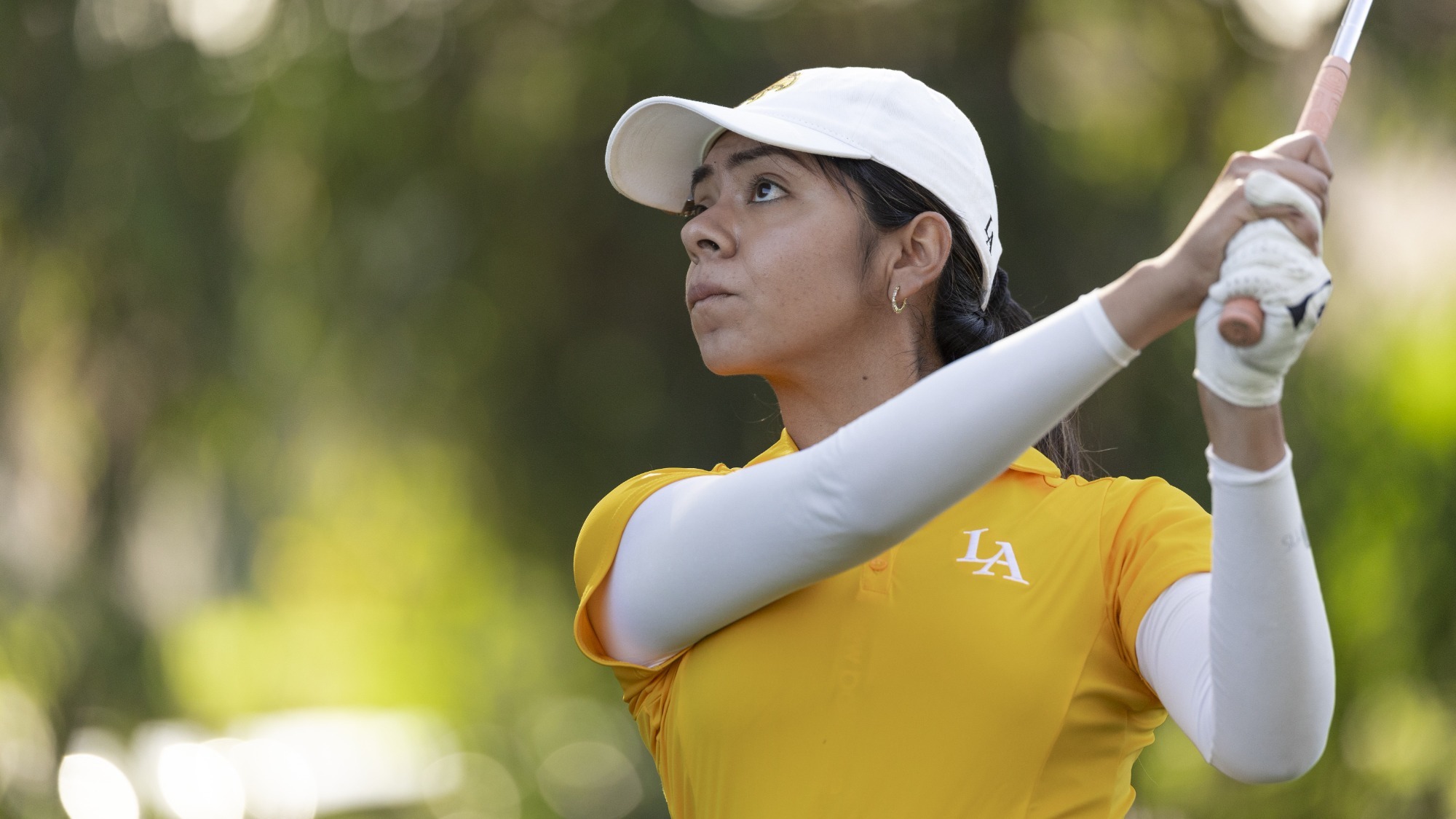 joshlyn ayala follows her golf as it heads toward the green