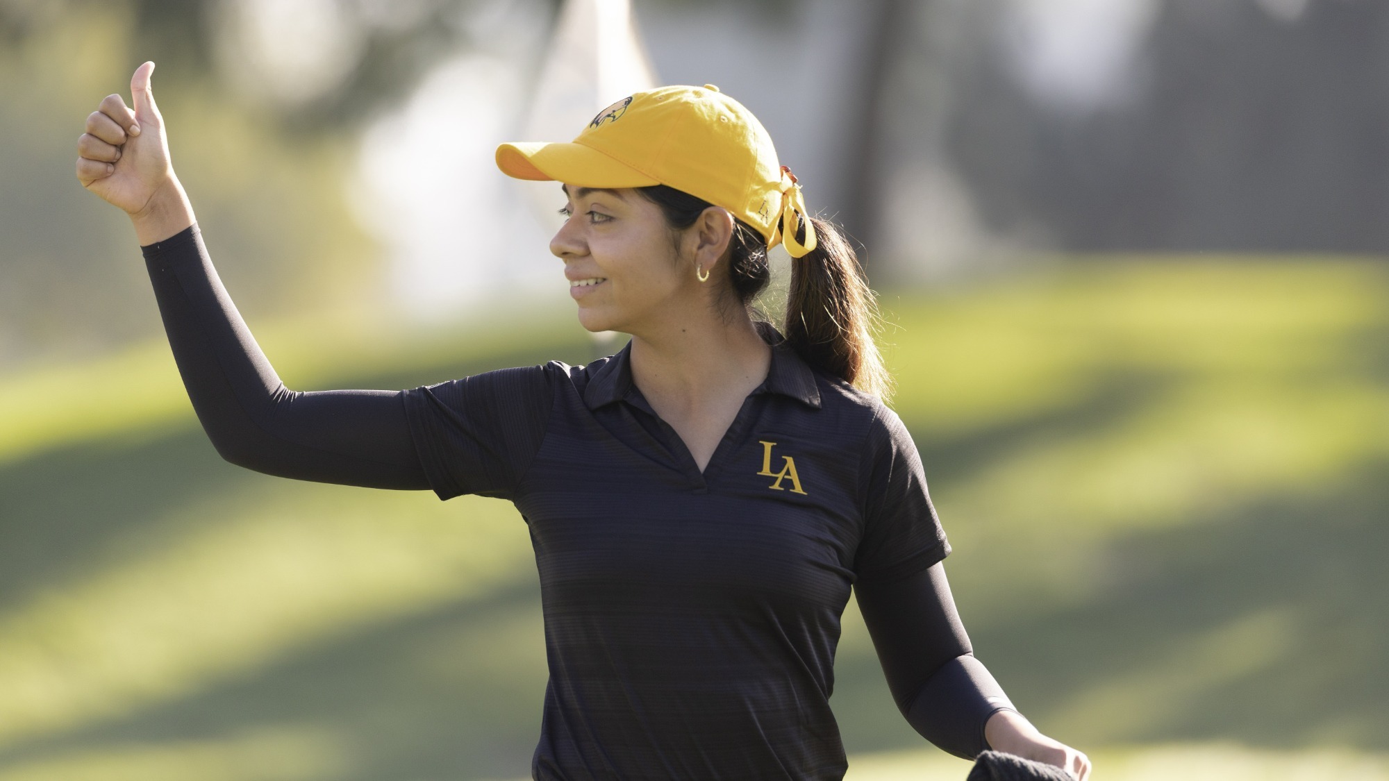 joshlyn ayala gives a thumbs-up after a good shot