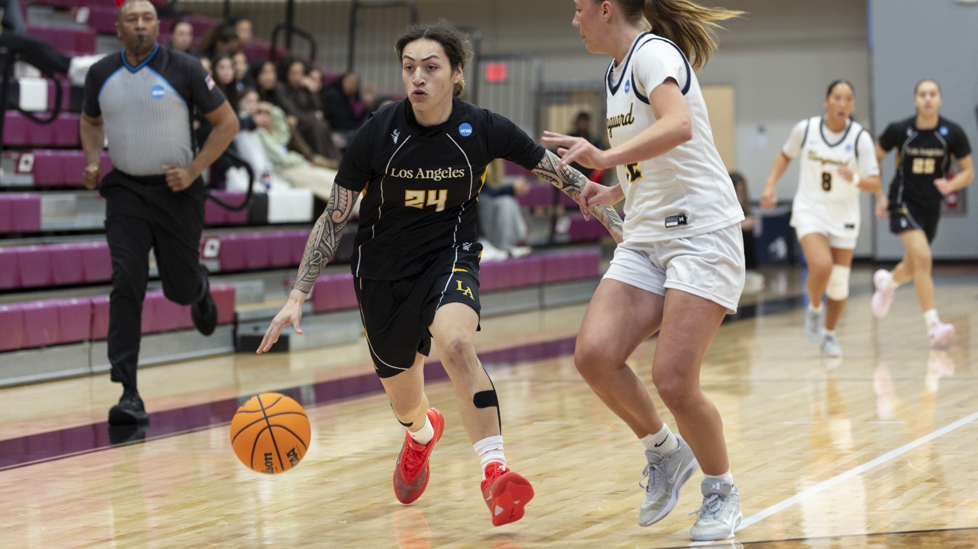 nevaeh asiasi drives against a defender from vanguard