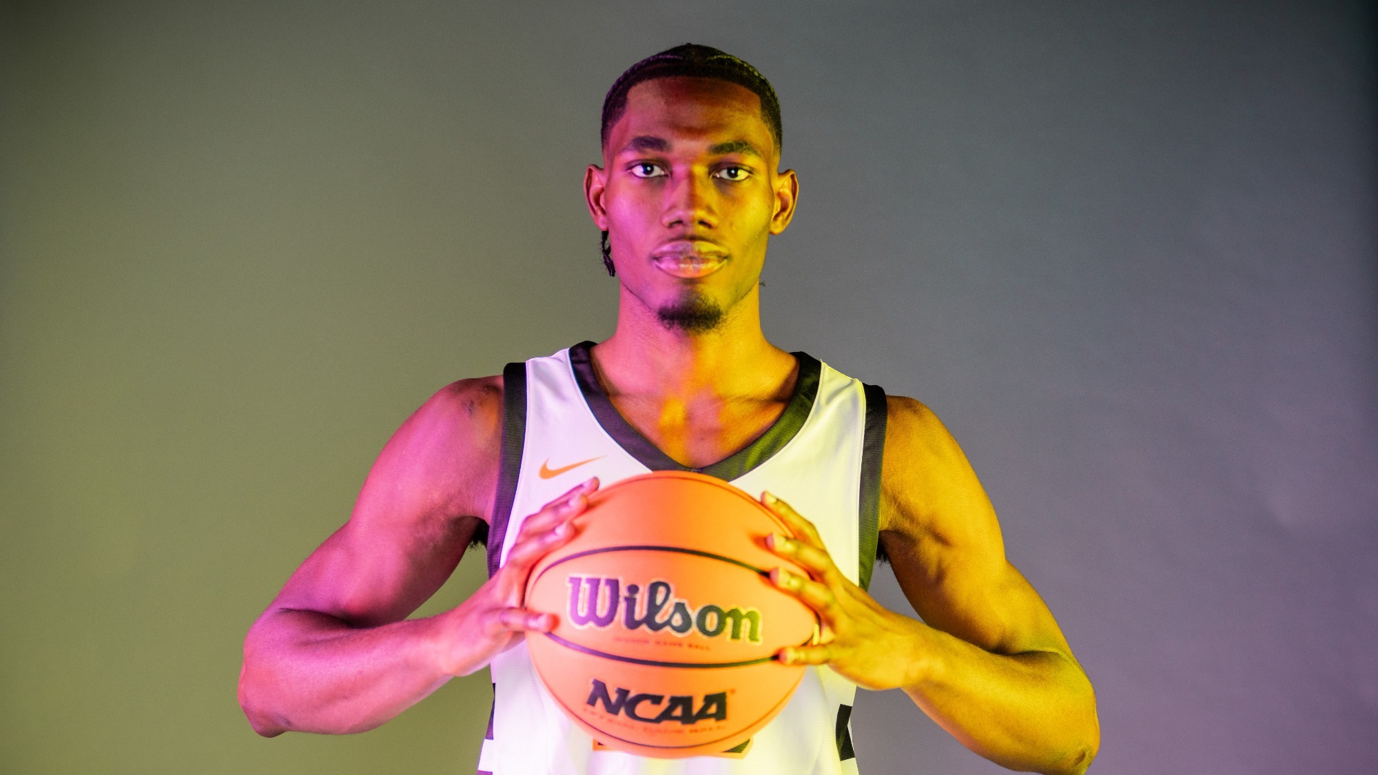 deraje agbaosi holds a basketball at media day