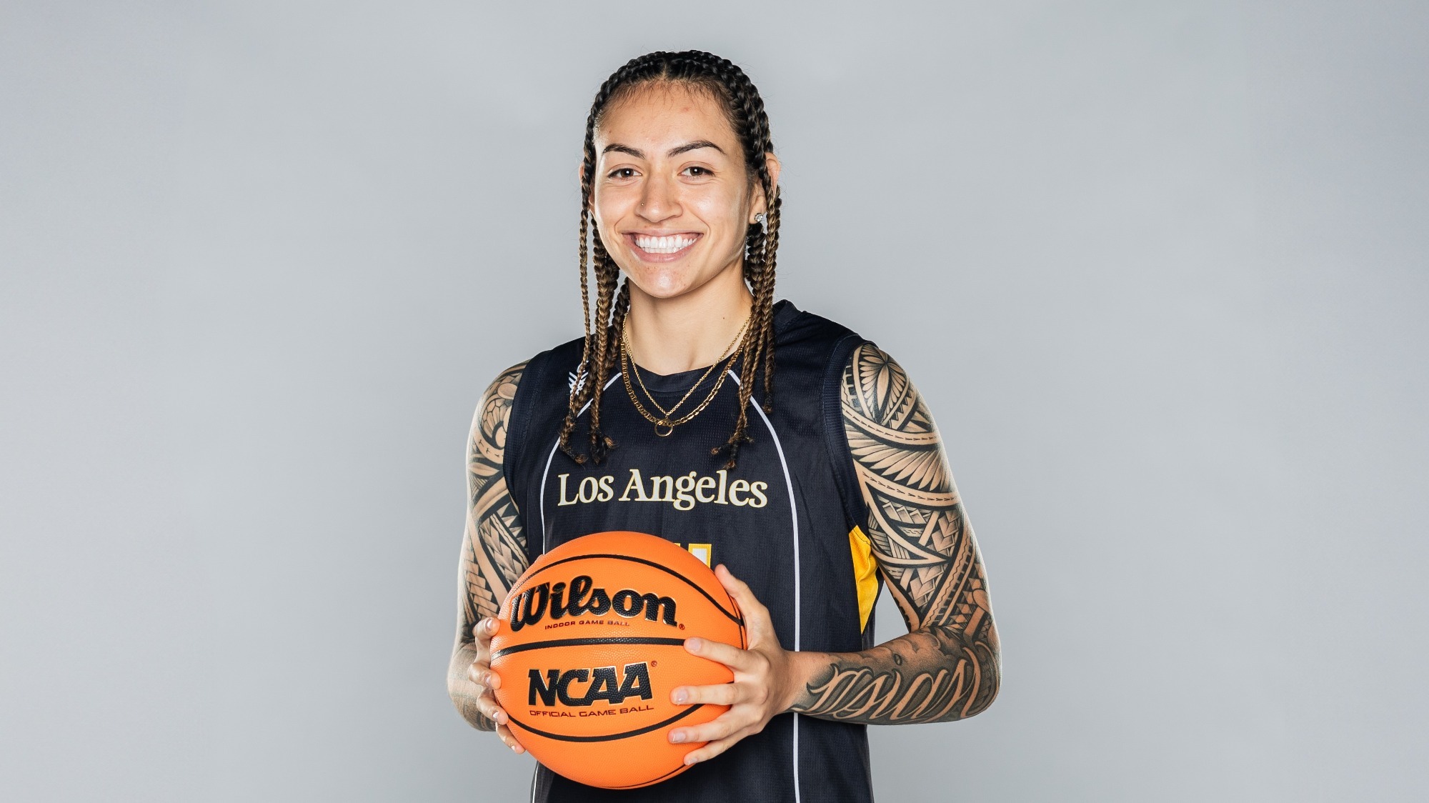 nevaeh asiasi poses with a basketball on media day