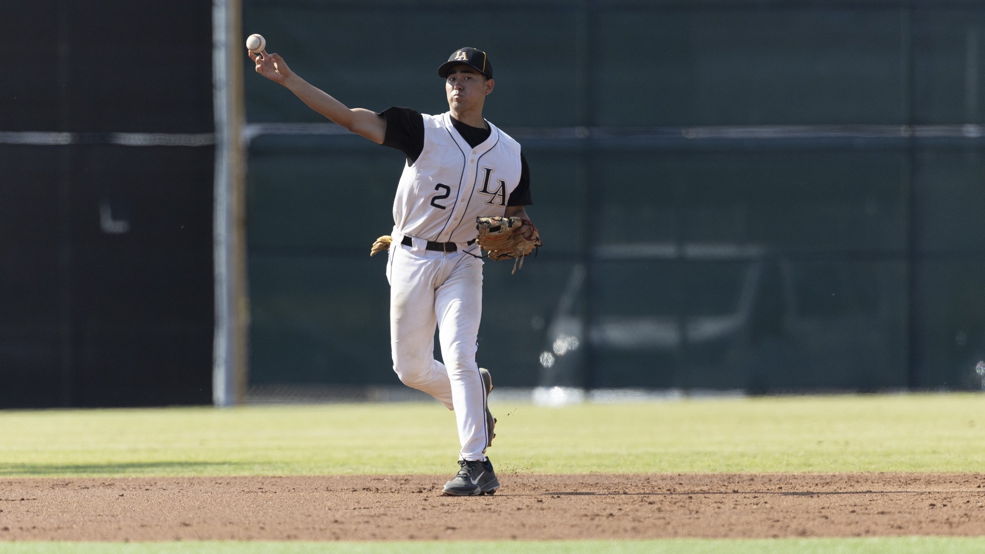 ethan gonzalez makes a throw to first base