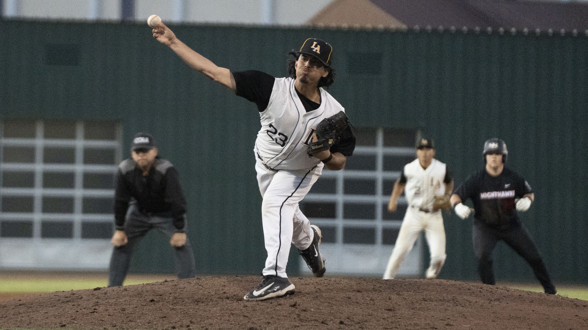 jared robles fires a pitch to the plate