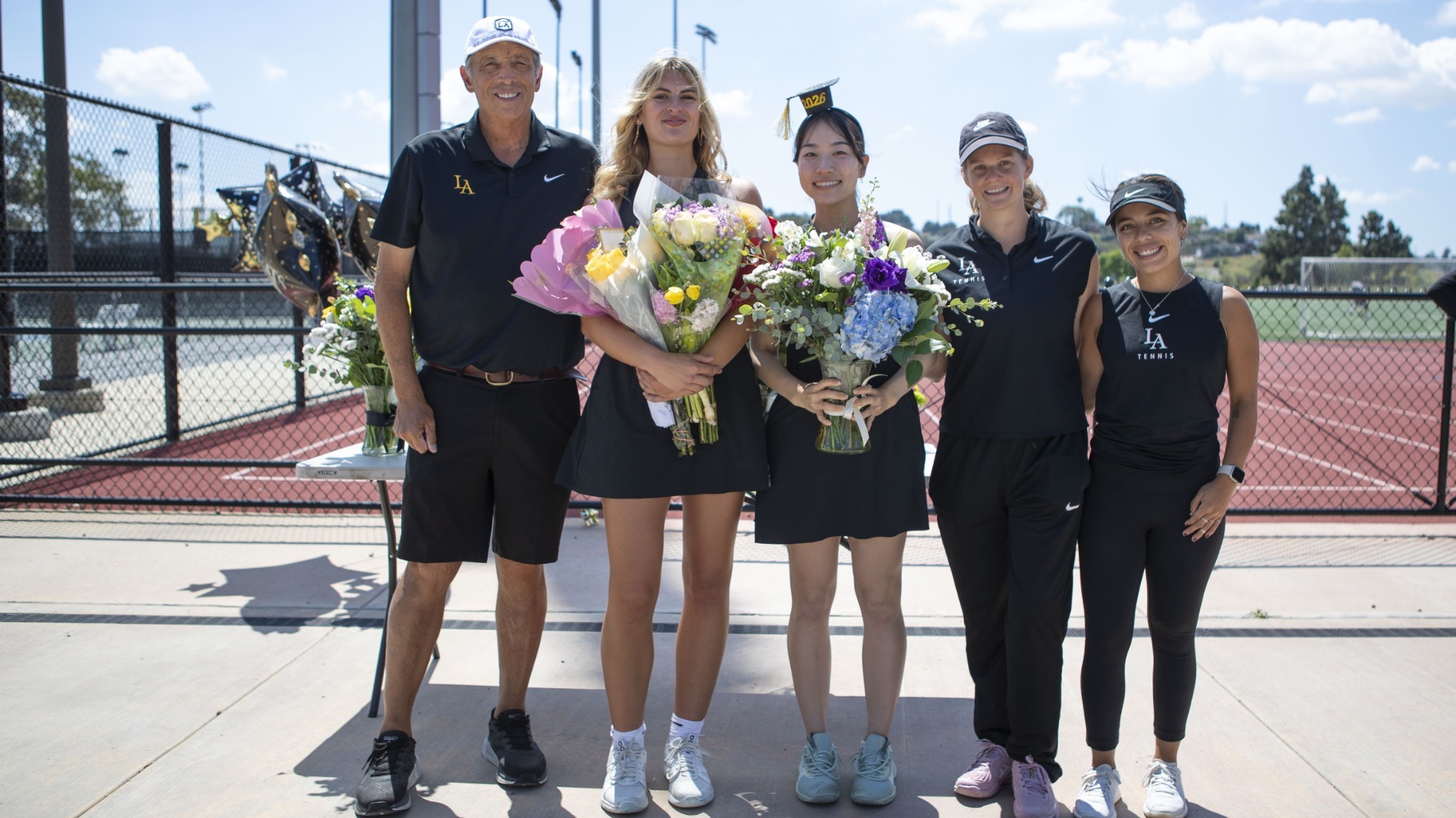 Head coach Richard Gallien, seniors Maldini Simic and Hideka Takamura and assistants Luciana Di Laura and Chelsey Ruiz at Senior Day
