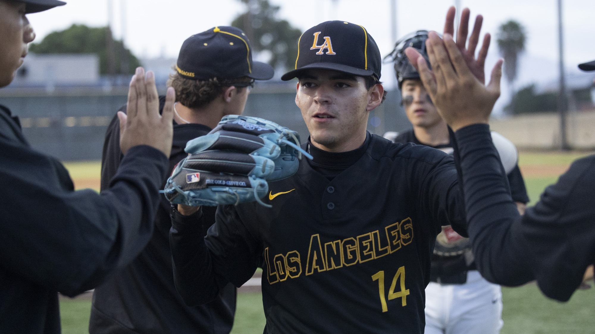 ismael quintero is congratulated by teammates entering the dugout