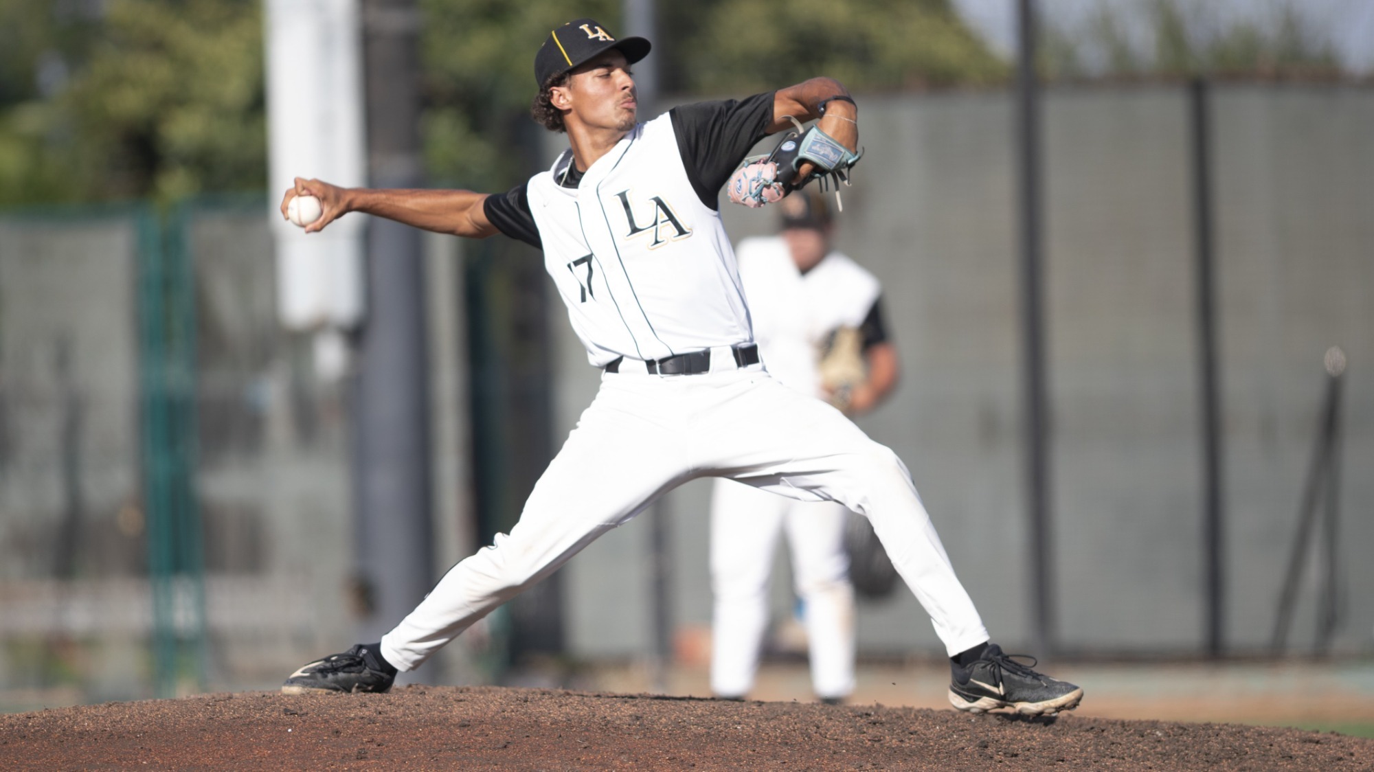 jonathan manuel throws a pitch to the plate