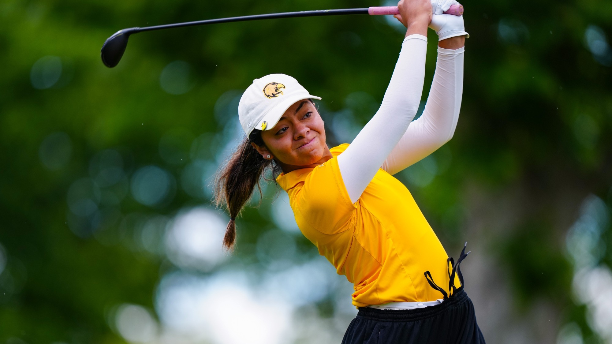 joshlyn ayala hits a drive in the opening round of the ccaa championships