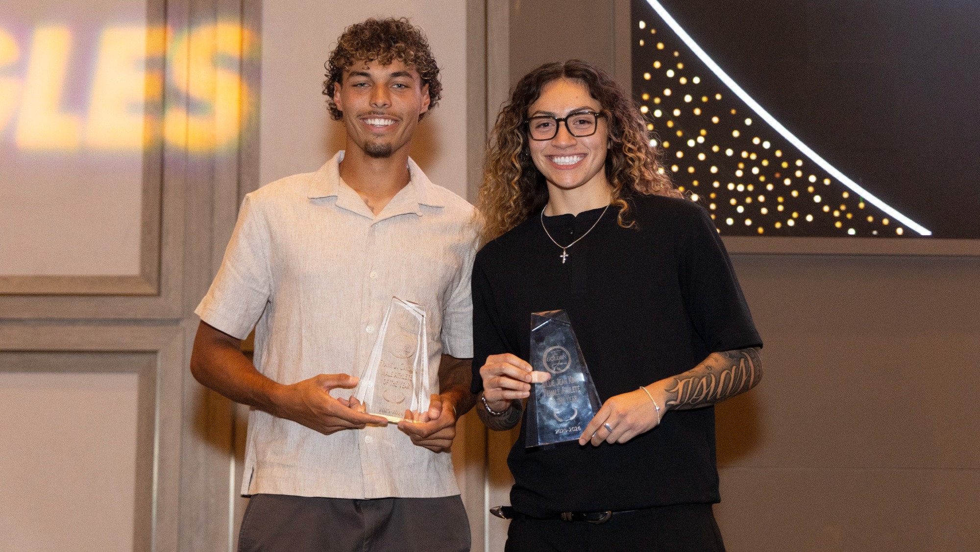 jonathan manuel and nevaeh asiasi display their top male and female athlete awards