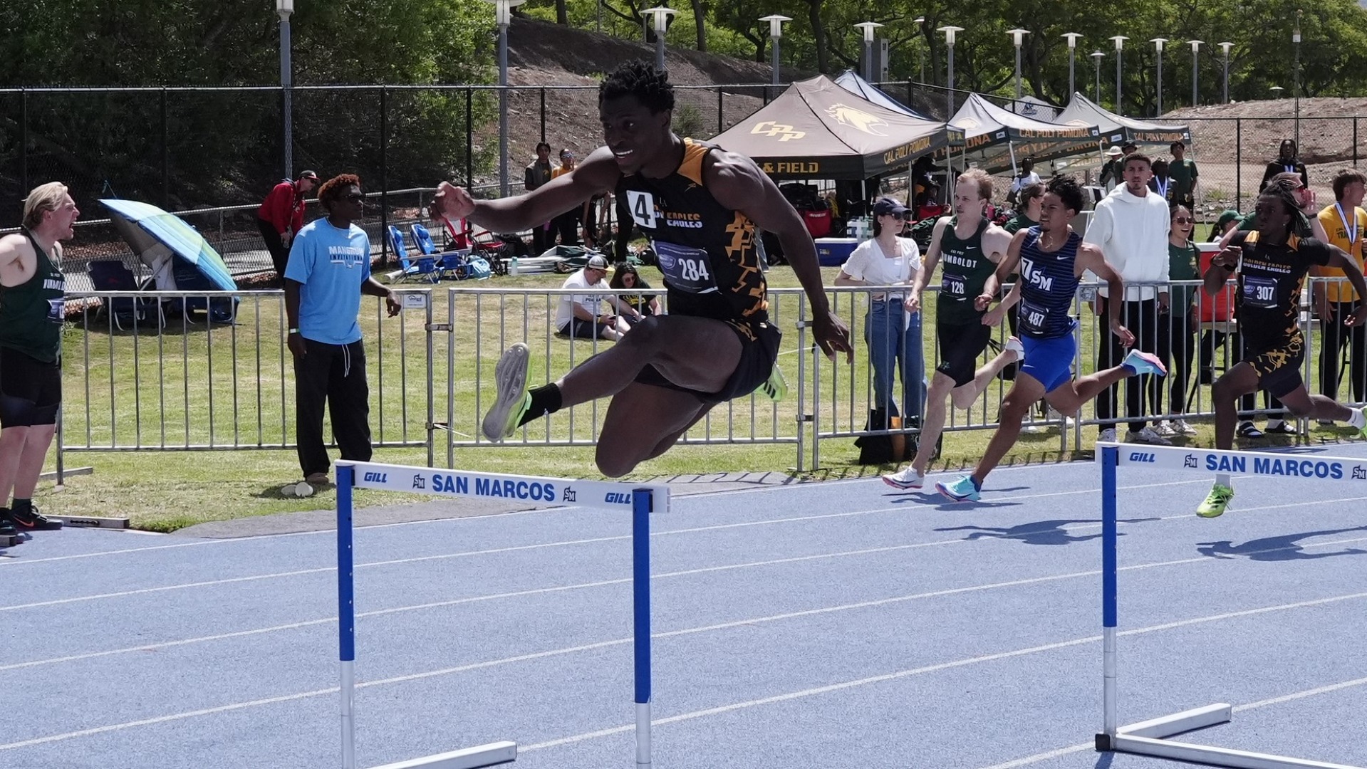 nicholas aninze clears a hurdle