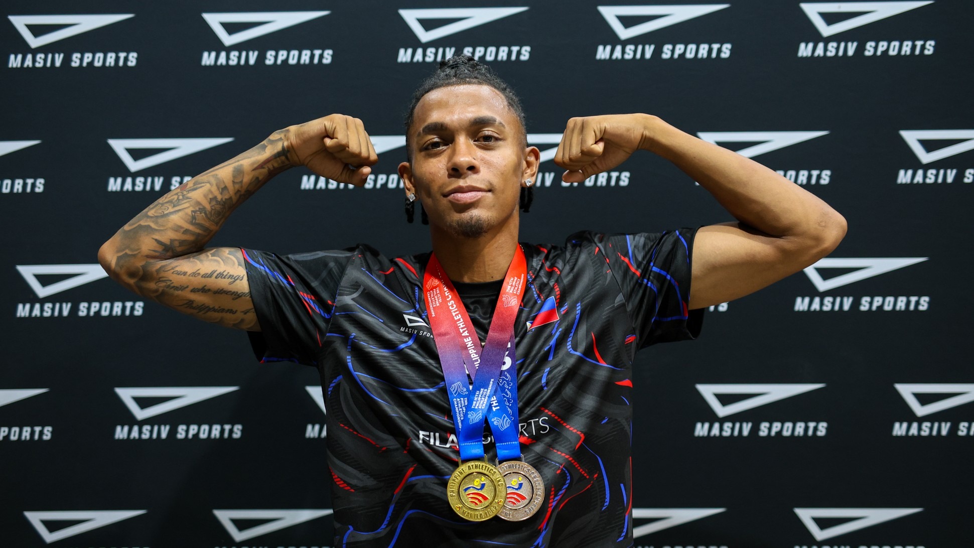 drew hill poses with gold and silver medals