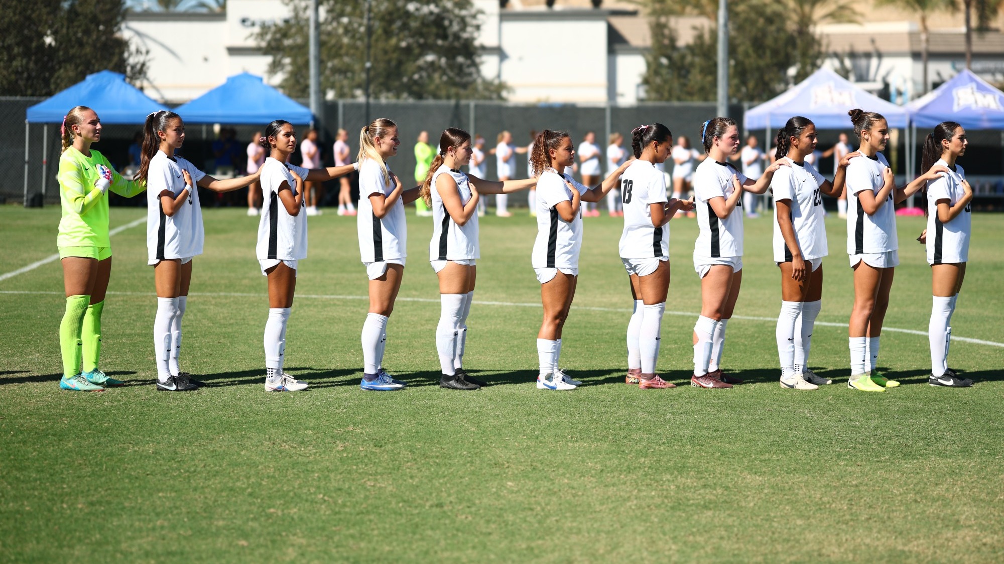 Women's Soccer Starters Standing for National Anthem