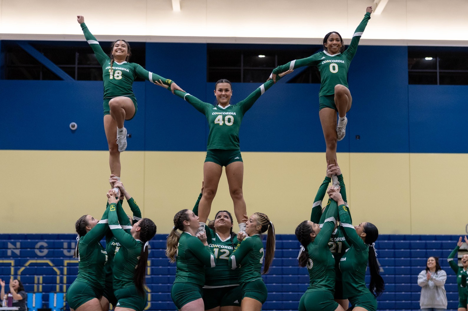Stunt holding three pyramids