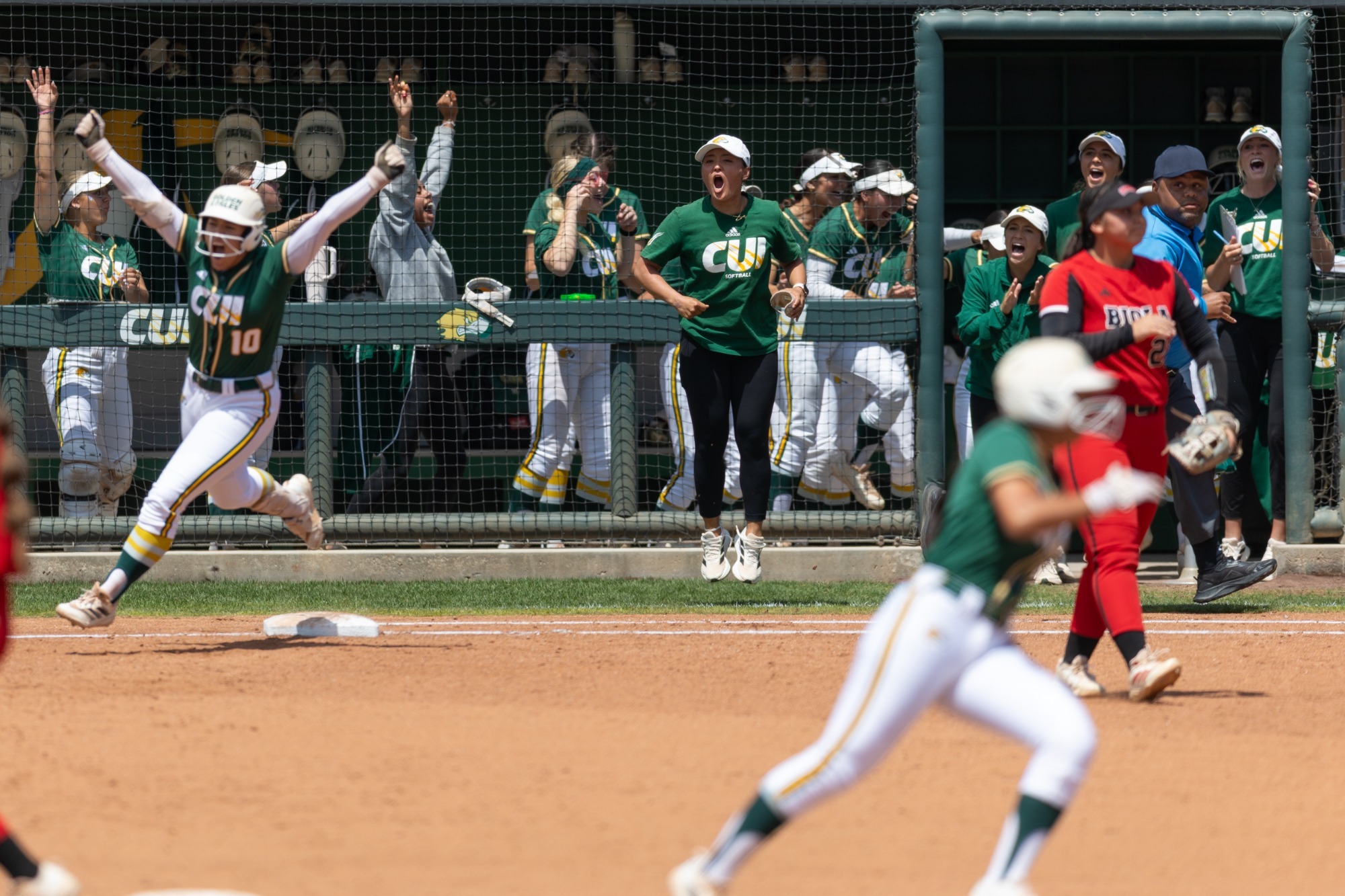 Kayla Rodgers rounding first base after HR vs Biola 2025 PacWest Tourney