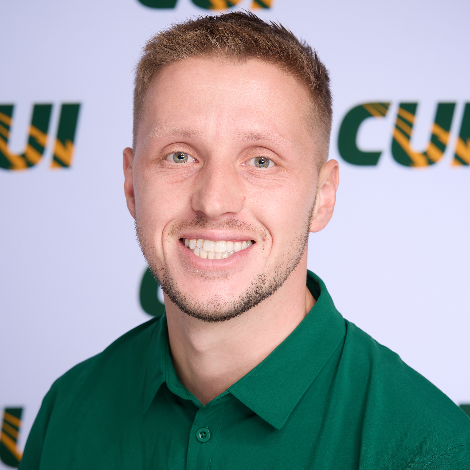 Josh Glover men's soccer coach smiling bio pic cropped