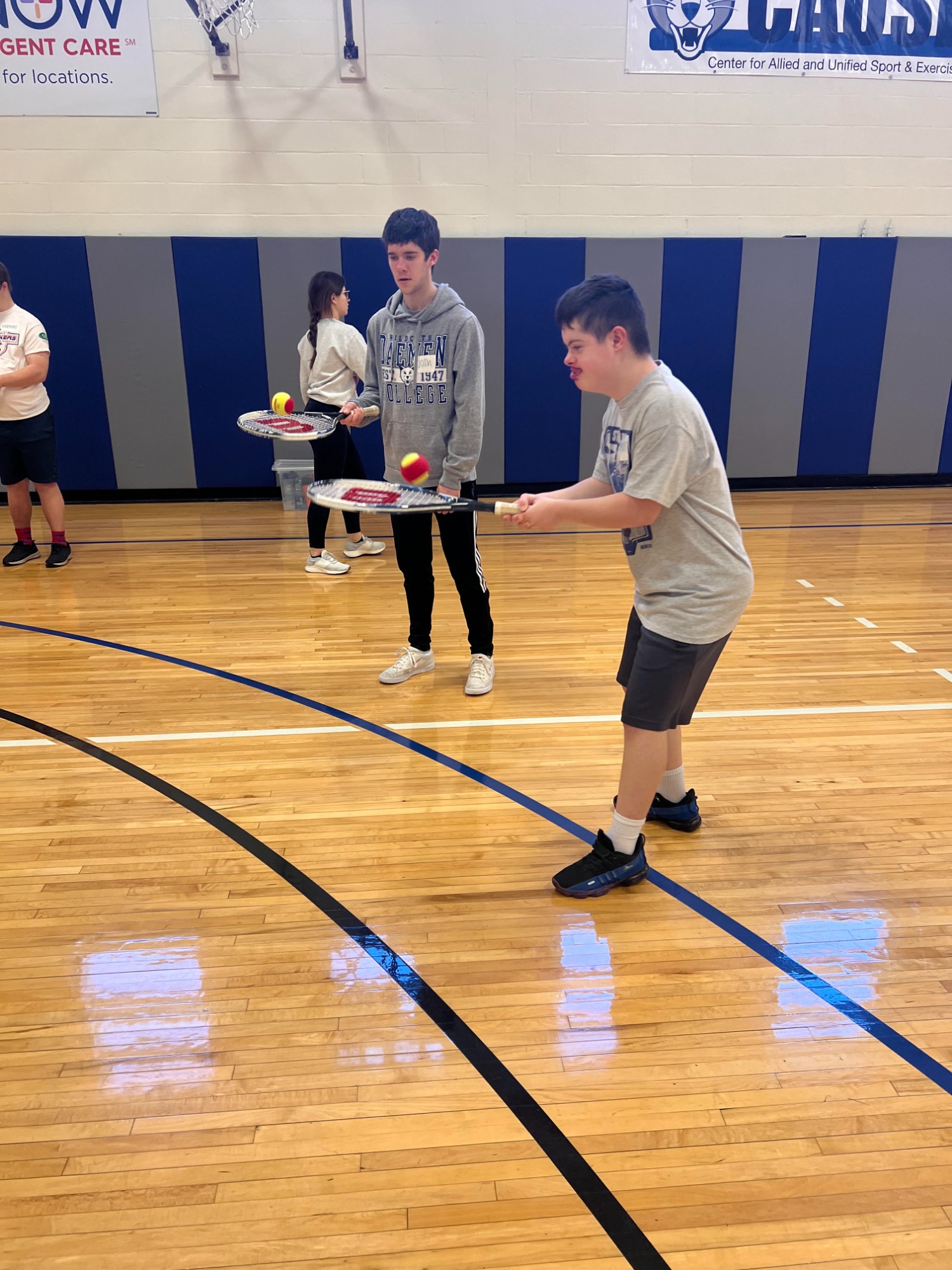 CAUSE teammates play keep up with tennis rackets and tennis balls