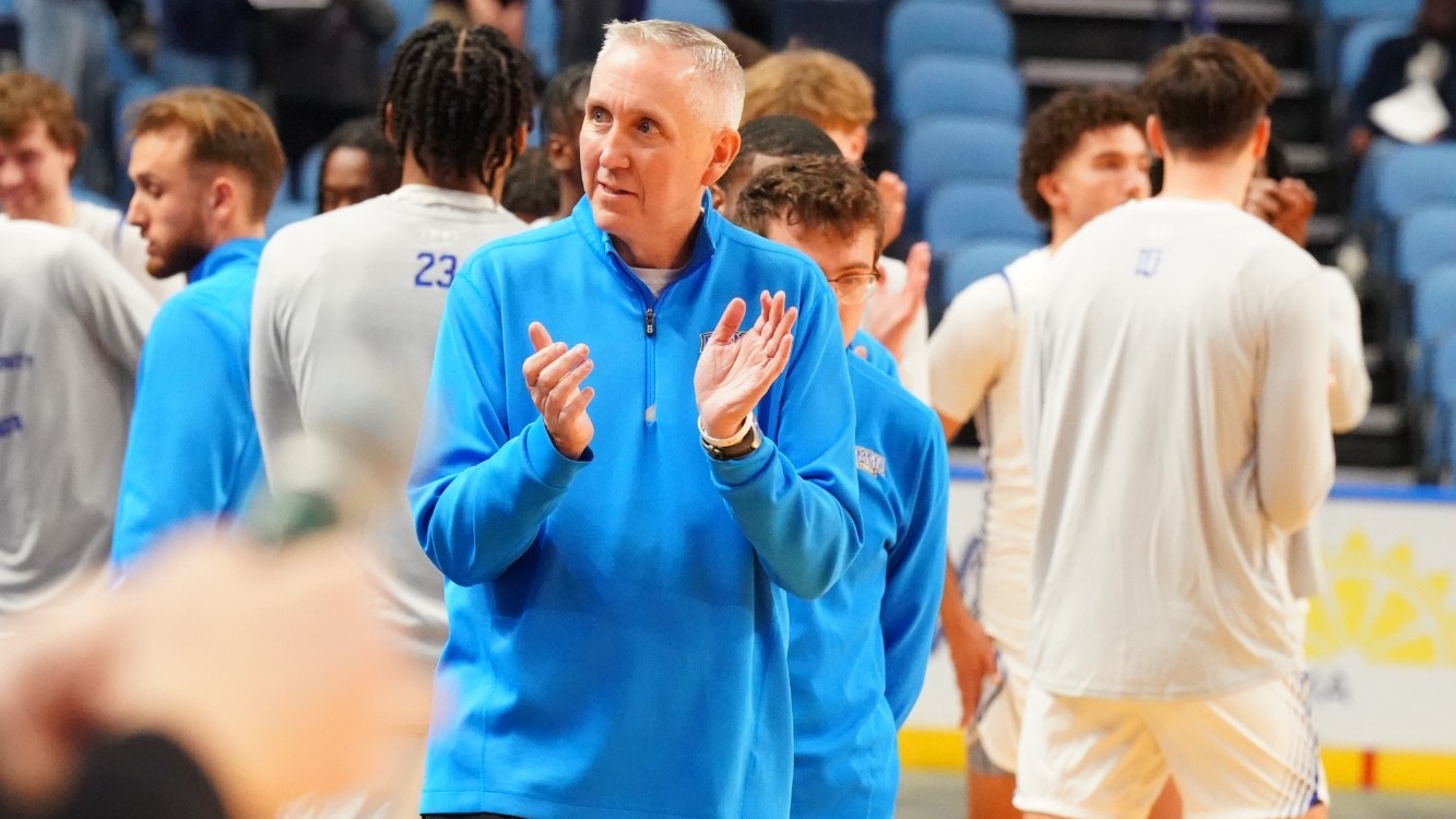 Mike MacDonald claps along the sideline prior to Daemen's game at KeyBank Center on Oct. 25, 2025