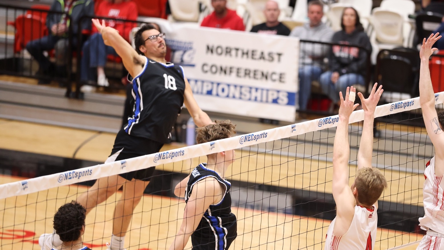 Billy Wieberg jumps and prepares to swing at the ball