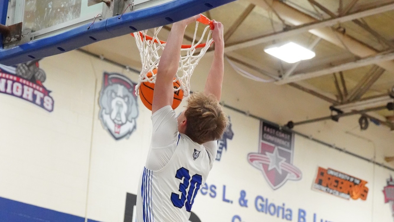 Jackson Kulik dunks the ball with 2 hands through the rim