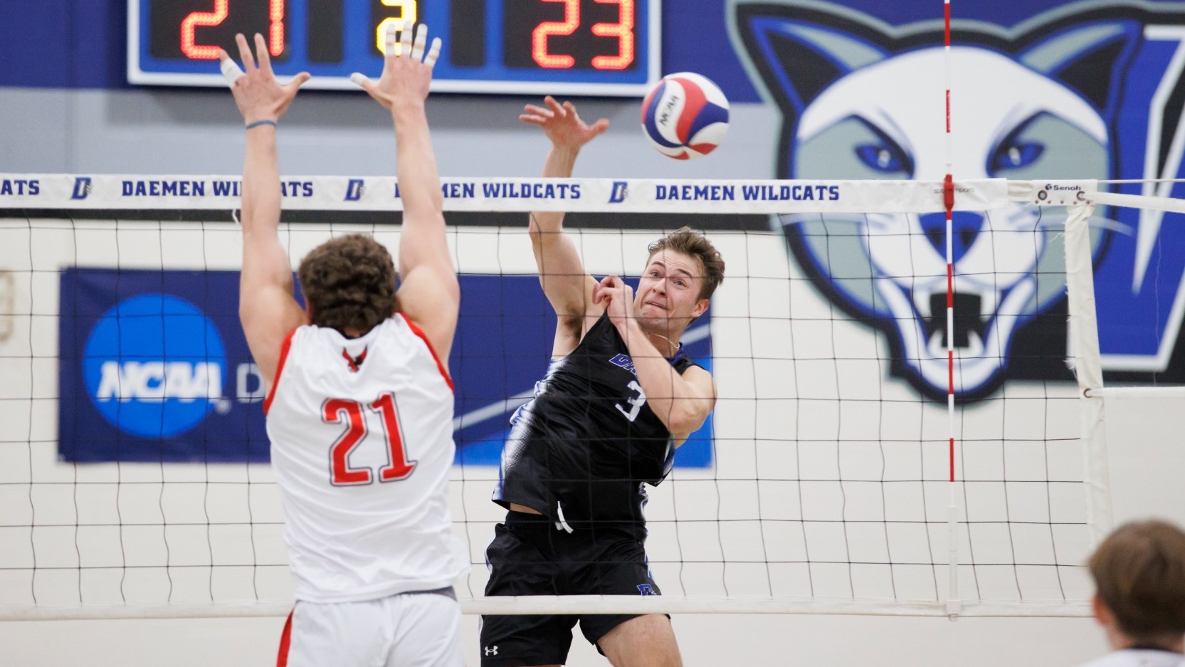 Johnaustin Bly attacks at the net as a Roberts Wesleyan defender attempts to block