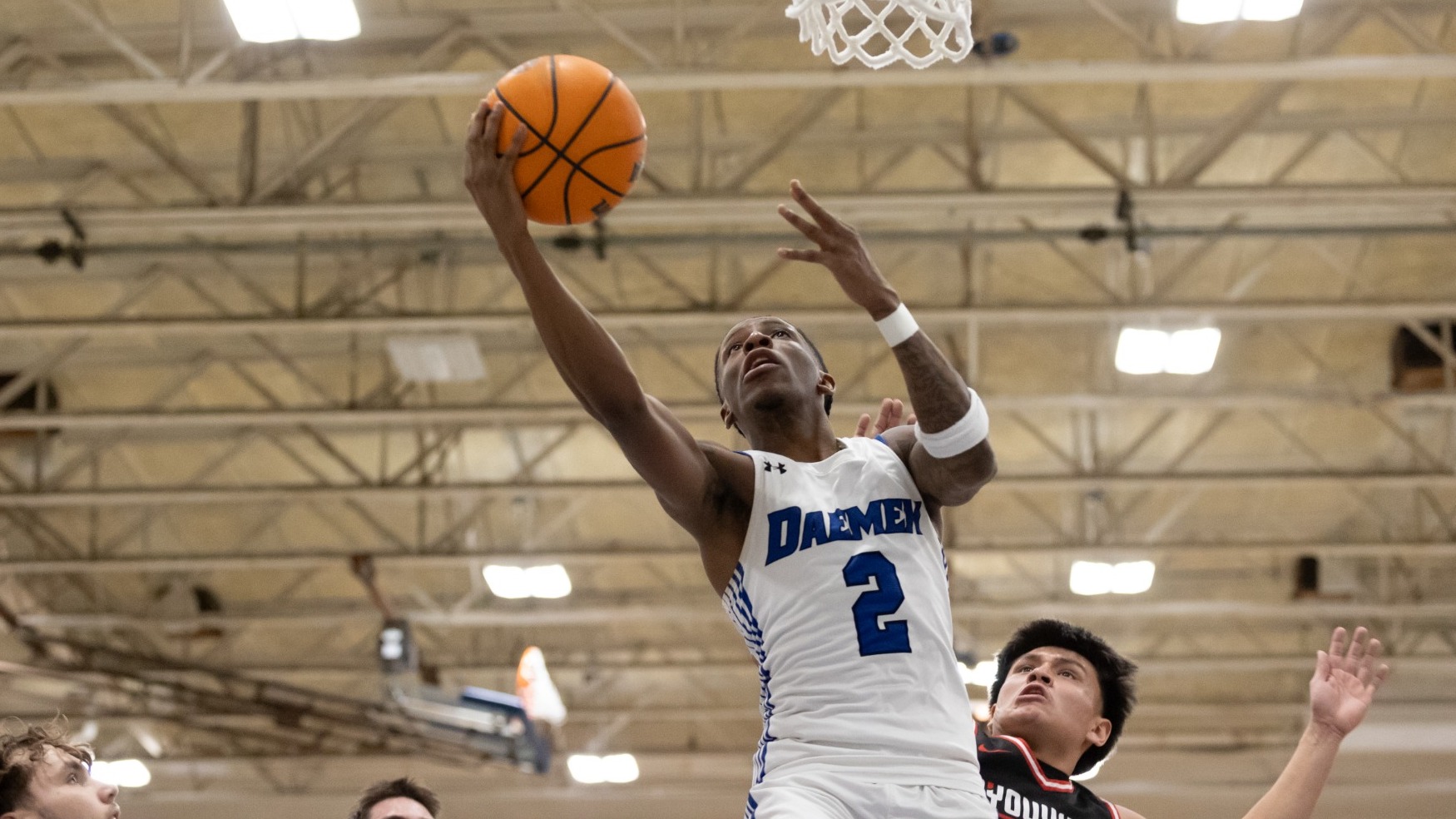 Ryan Heath glides to the basket, extending the ball with his right hand before shooting a layup