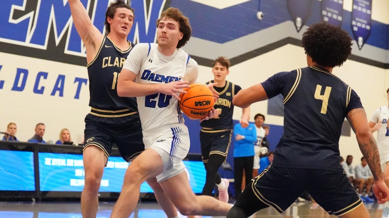 Zach Philipkoski splits between defenders on his way to the hoop