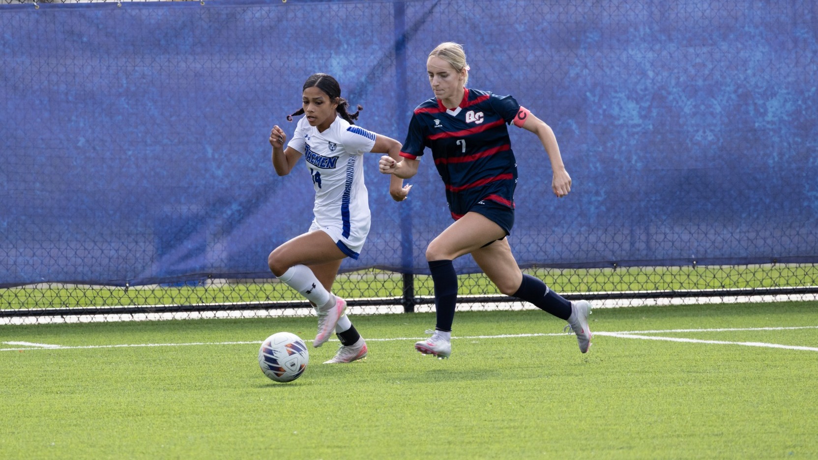 Mia Wright dribbles past defender