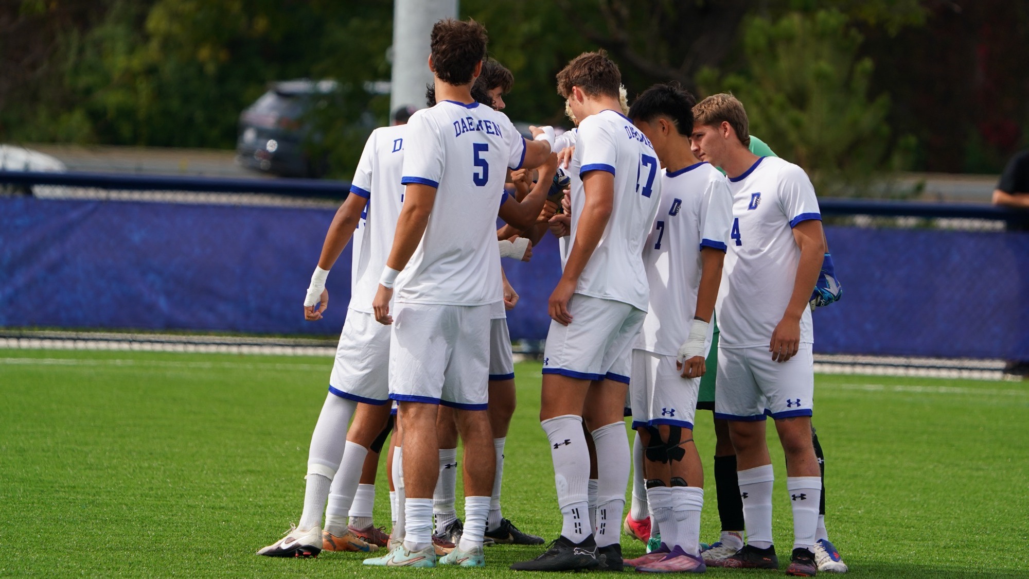 Men's soccer starters huddle