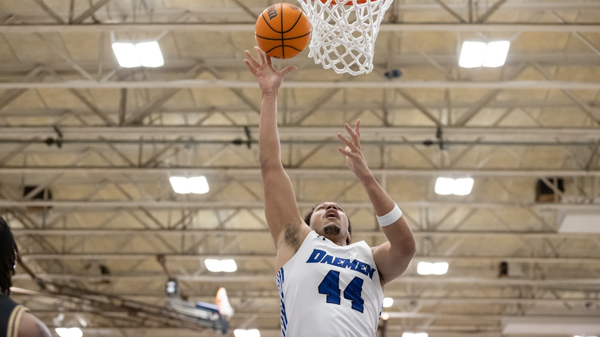 Benjamin Bill extends his arm and shoots a layup from point blank range