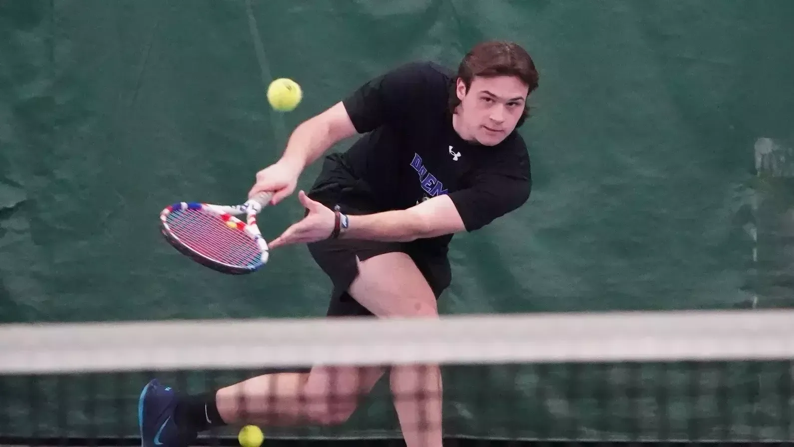 Vondin Henderson leans in after connecting on a backhand