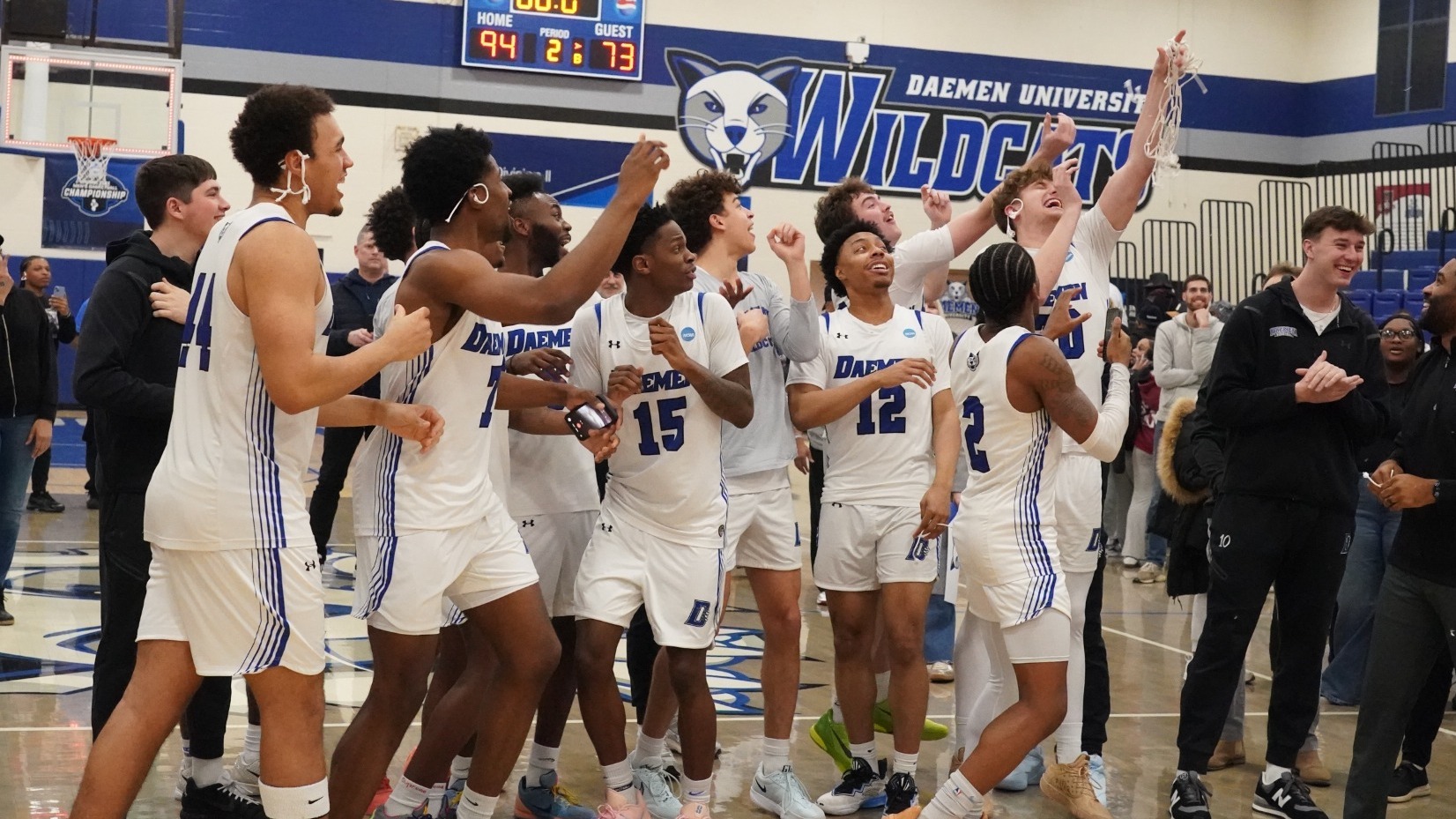 MBB celebrates with the net after winning East Region