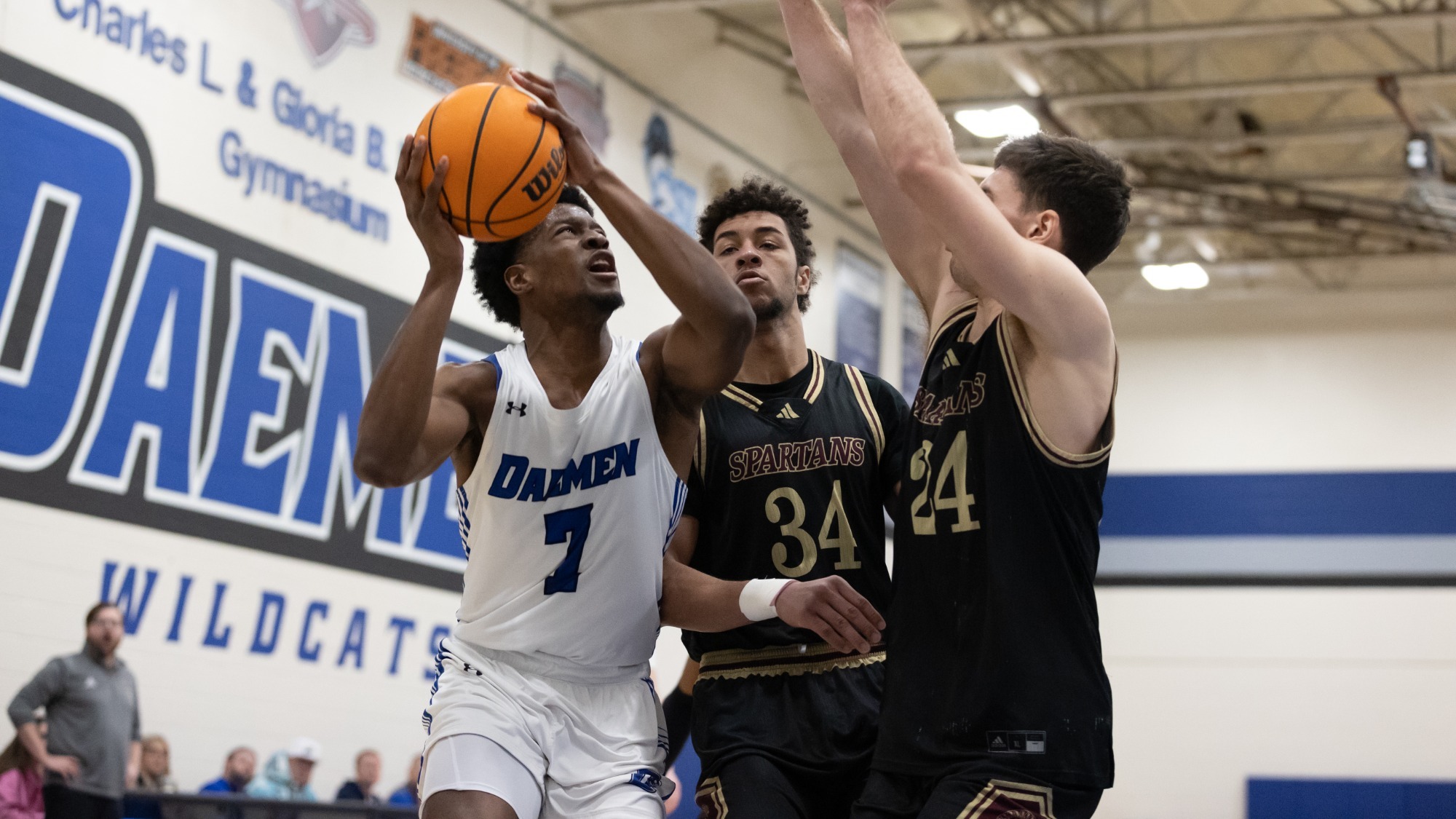 Phil Nwugwo goes up for a shot against two defenders