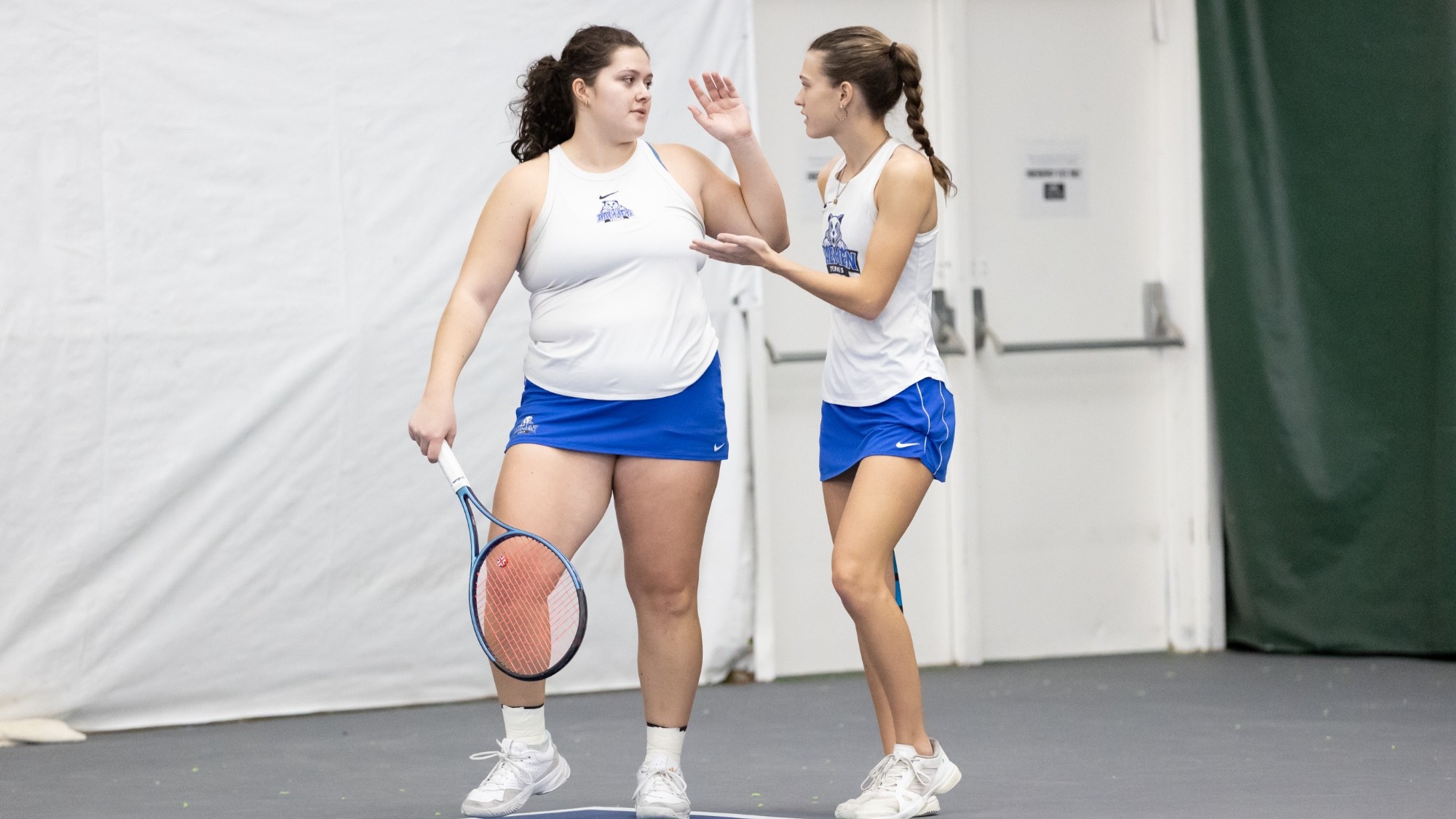 Women's tennis players high five