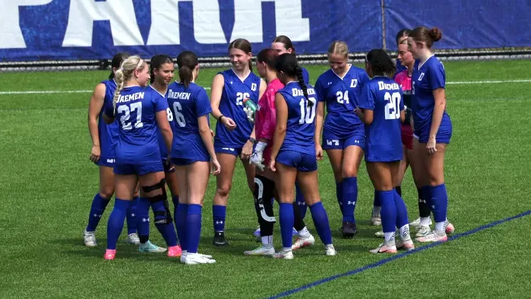 women's soccer huddle at practice