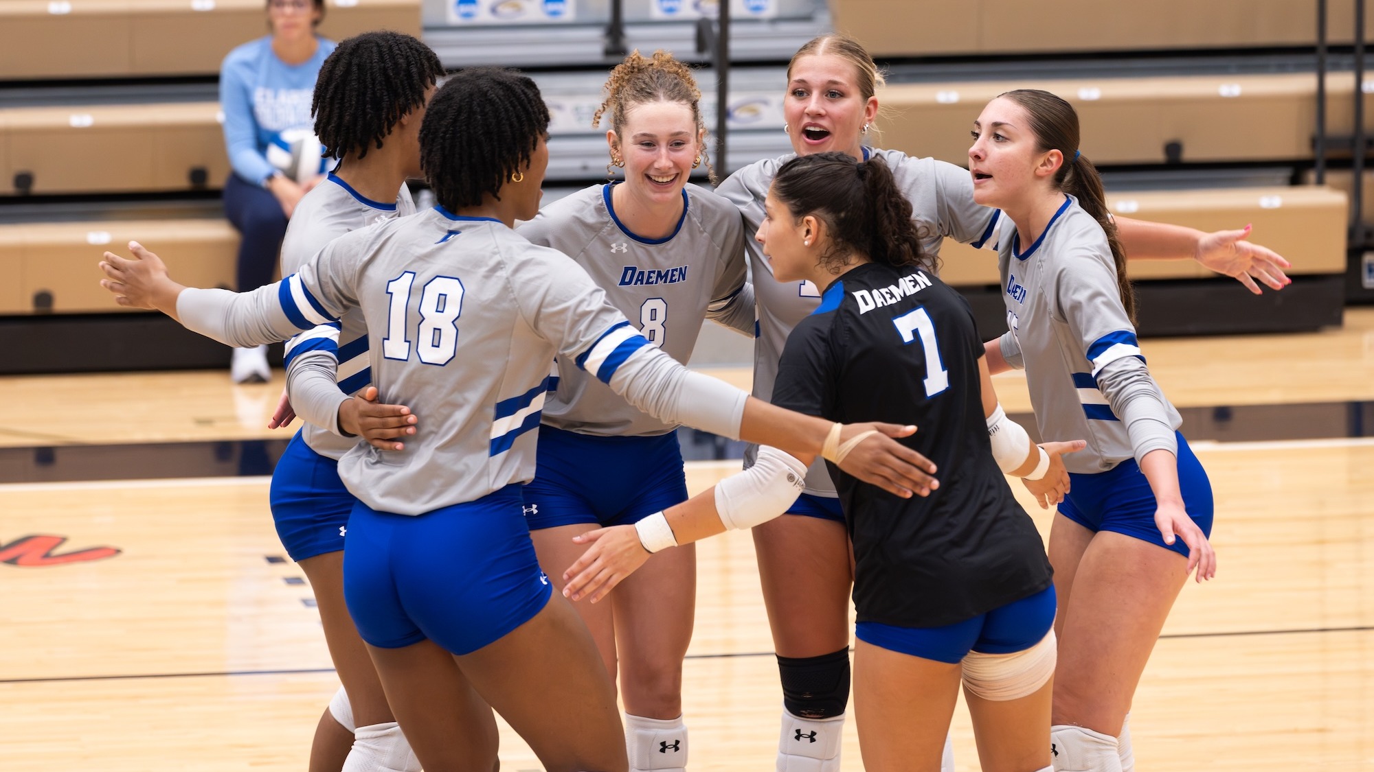 Women's volleyball celebrates a point