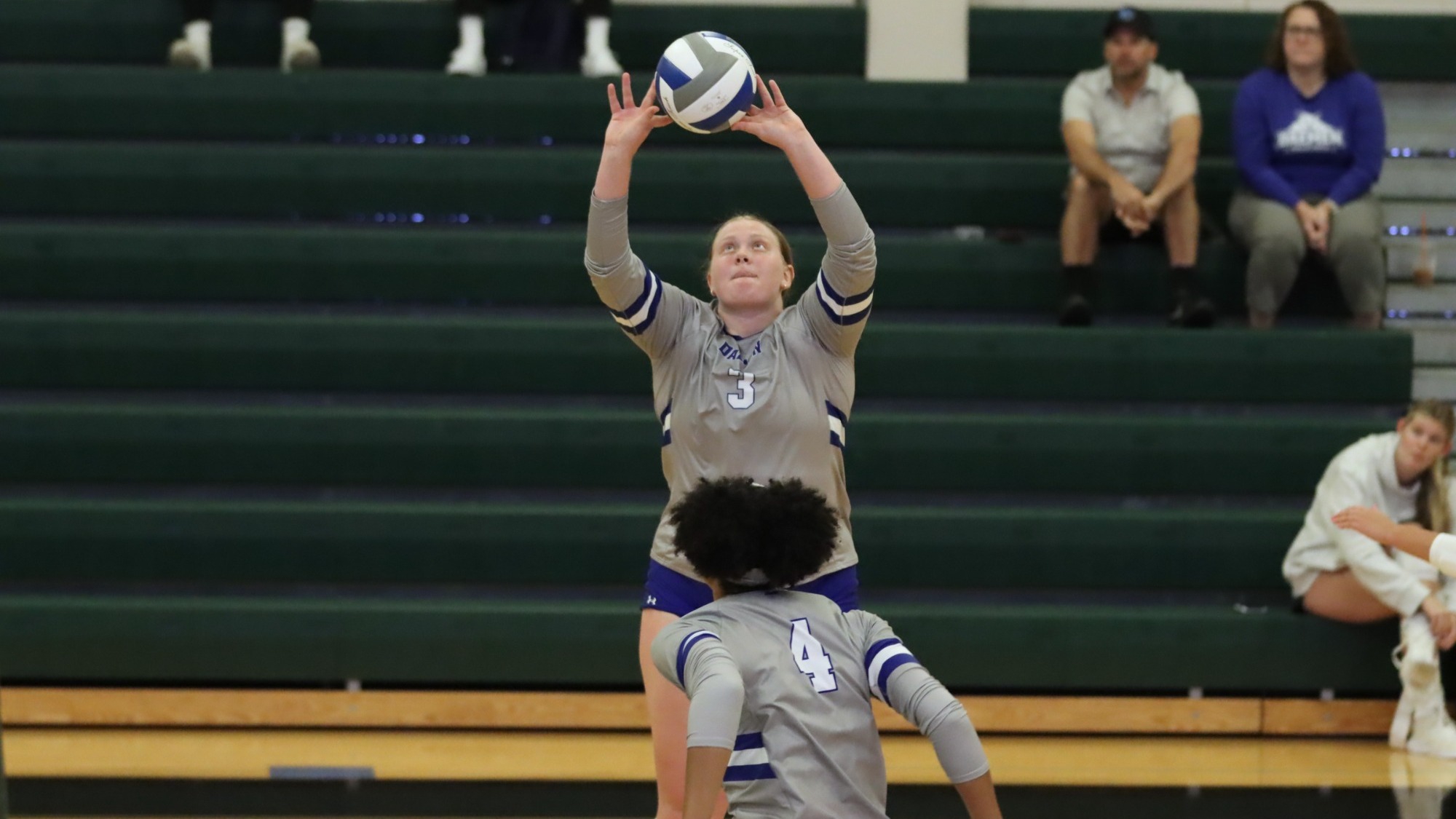 Maddie Schamaun sets a ball at Wildcat Classic