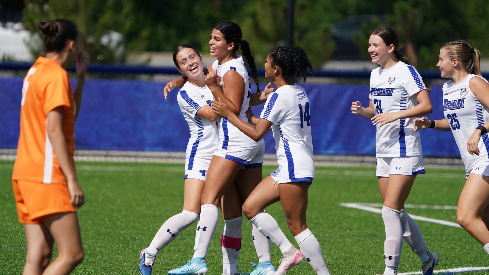 Zainab Khalid and women's soccer celebrate after goal vs. Post