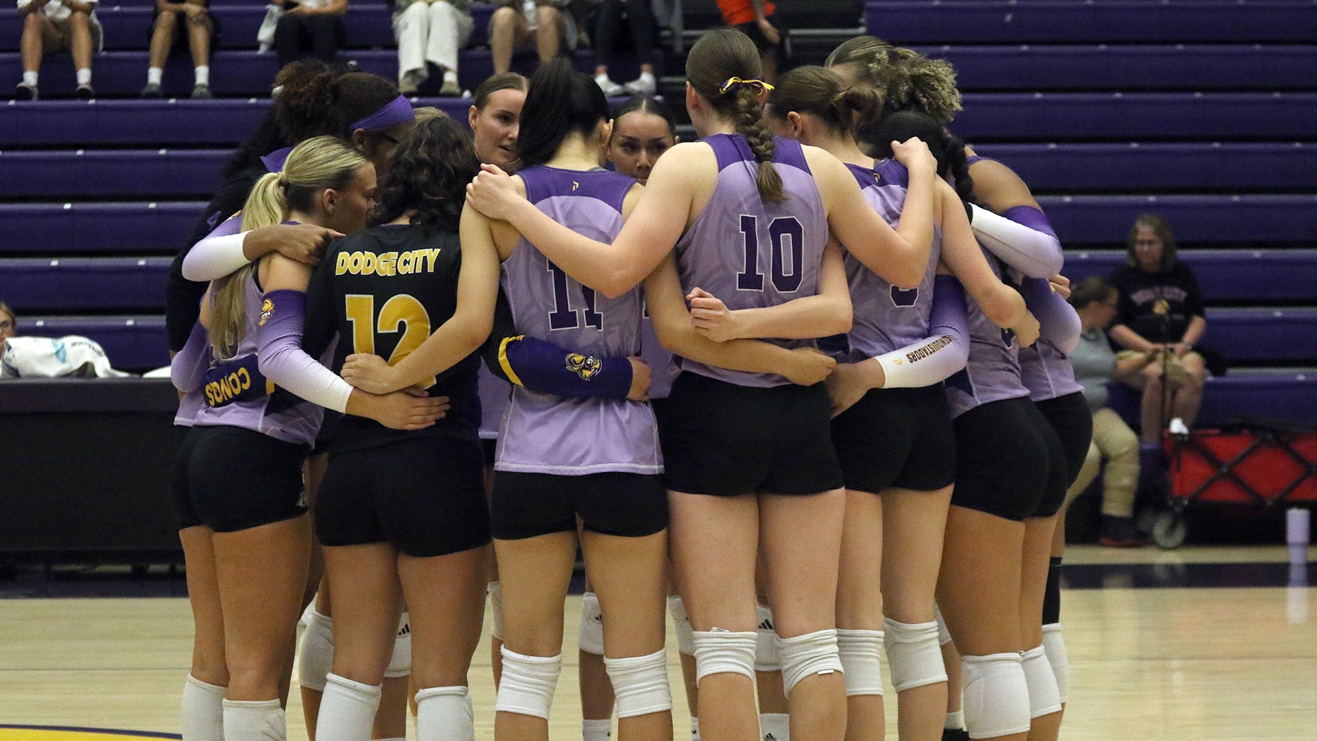 Dodge City CC Volleyball team huddling before a game