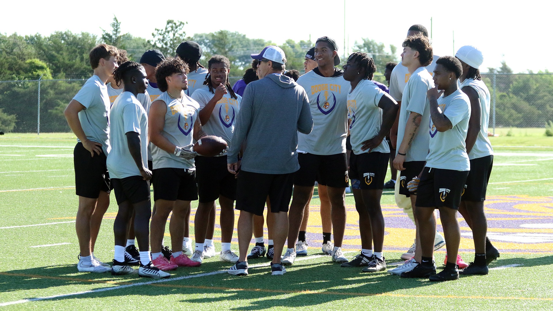 Dodge City CC Football Coach, Ryan Lusby talking with the offense during summer practice