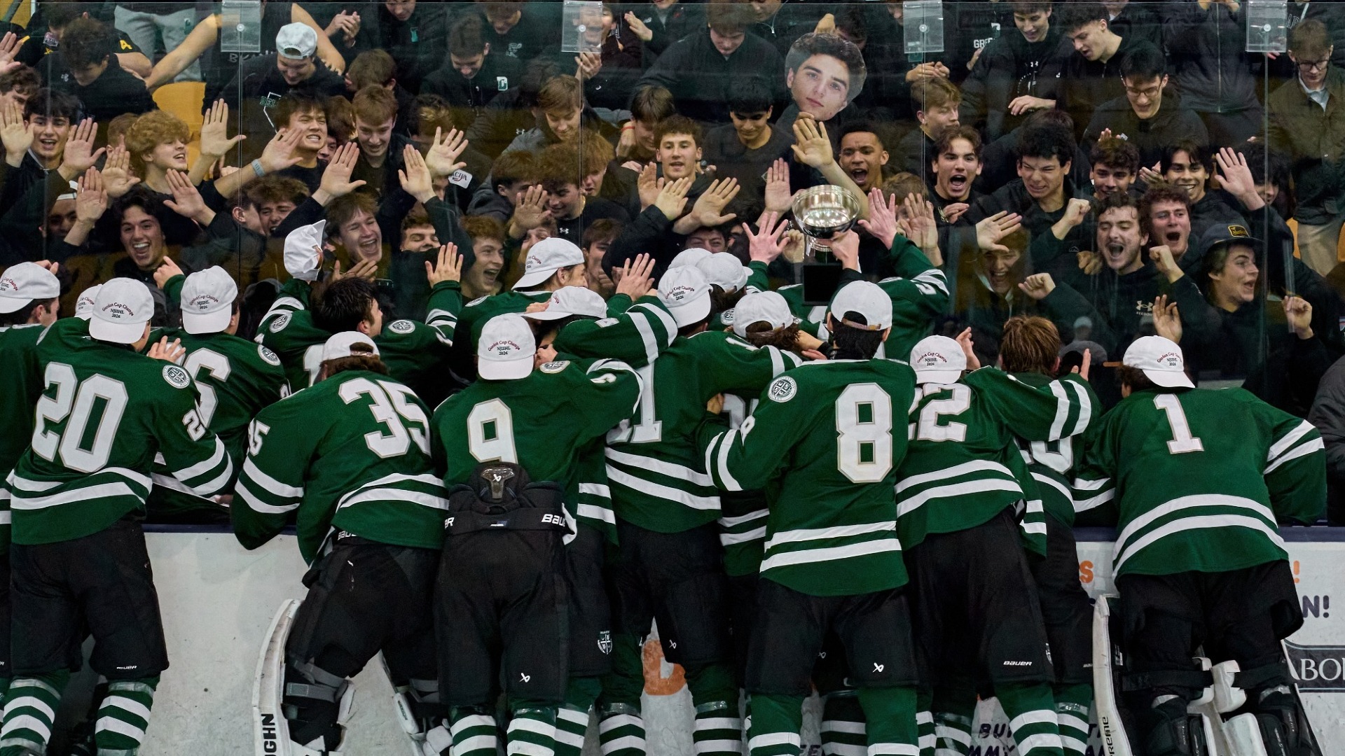 team celebrates with student section