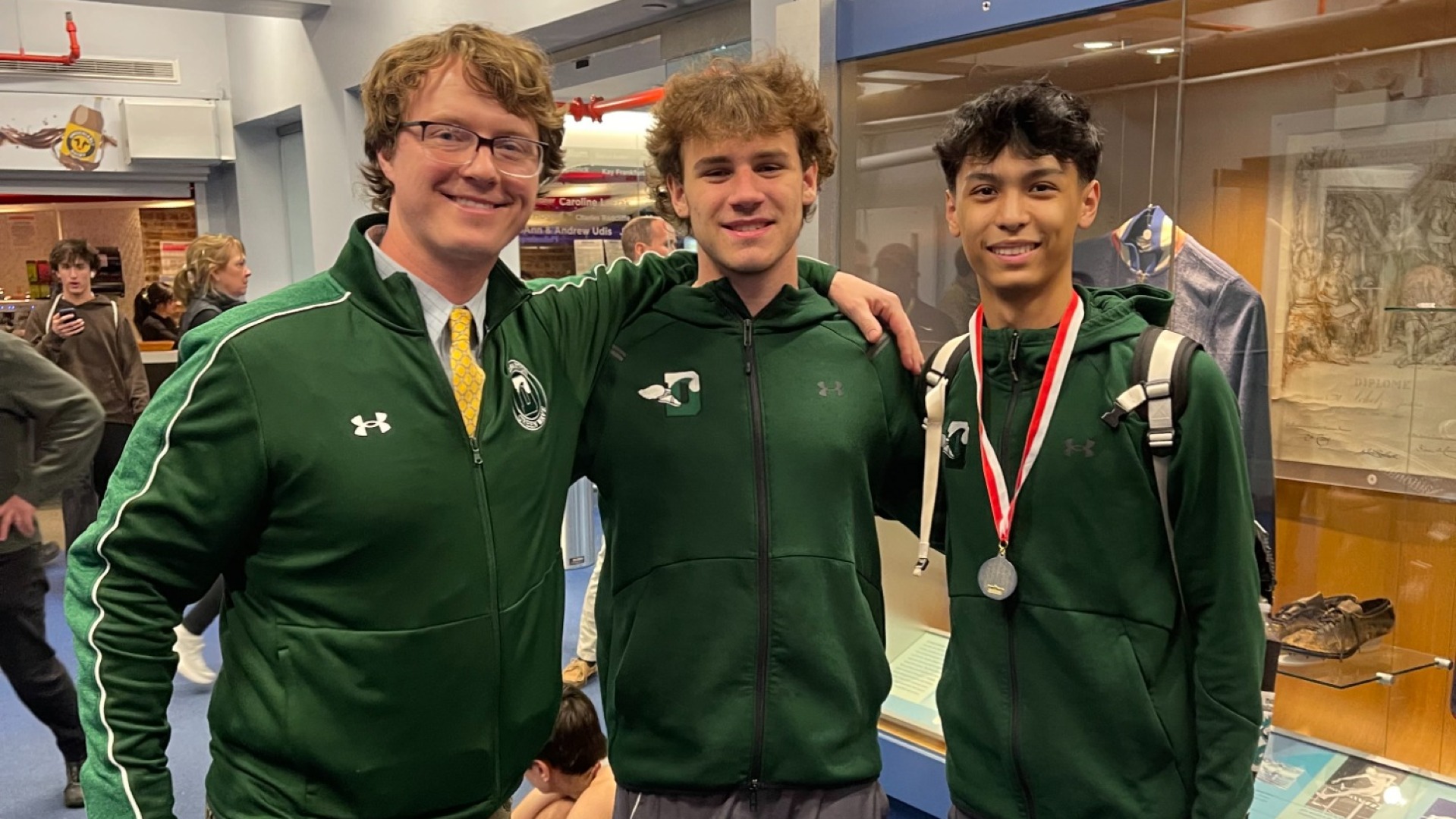 2 student runners with coach