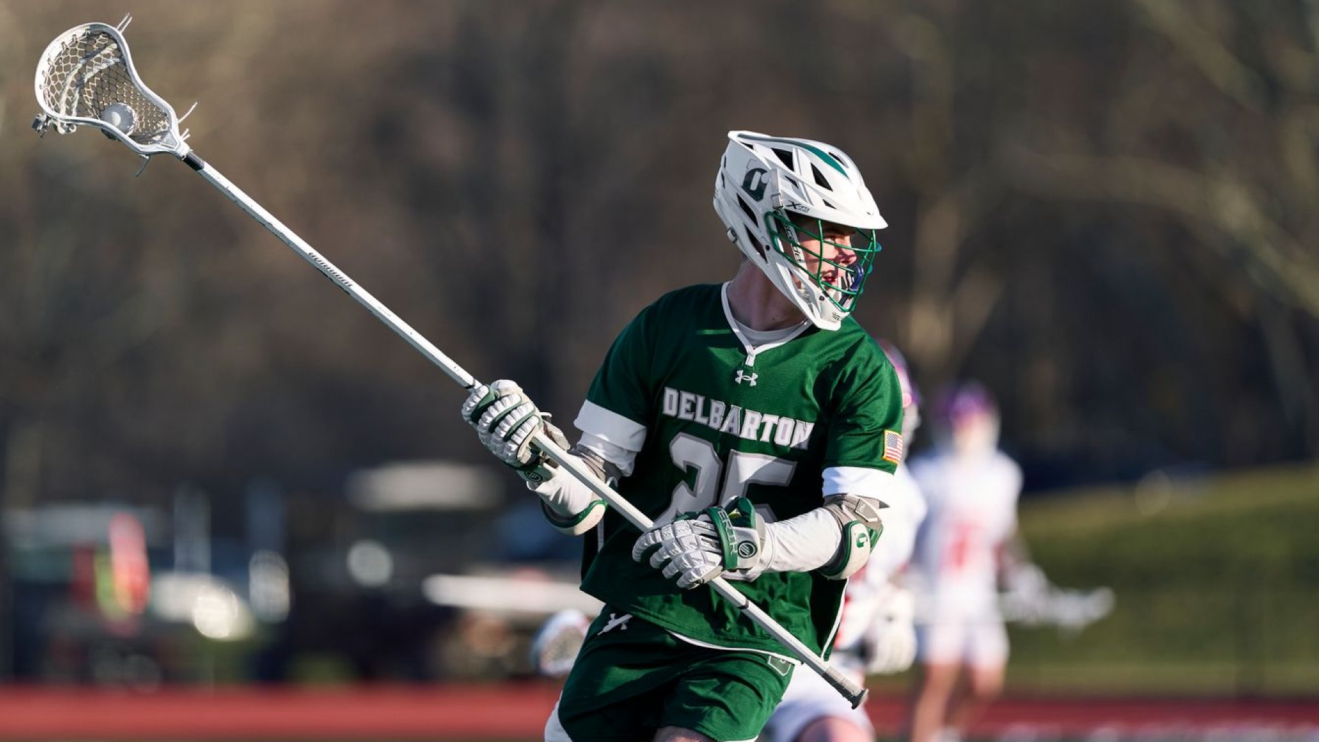 delbarton long stick midfielder runs with ball during game
