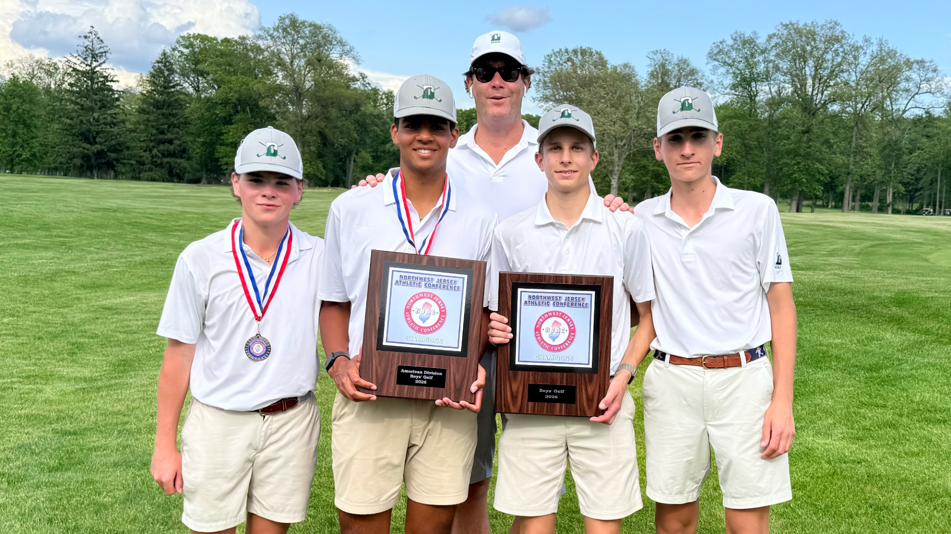 golf team poses with njac title with coach season flanagan