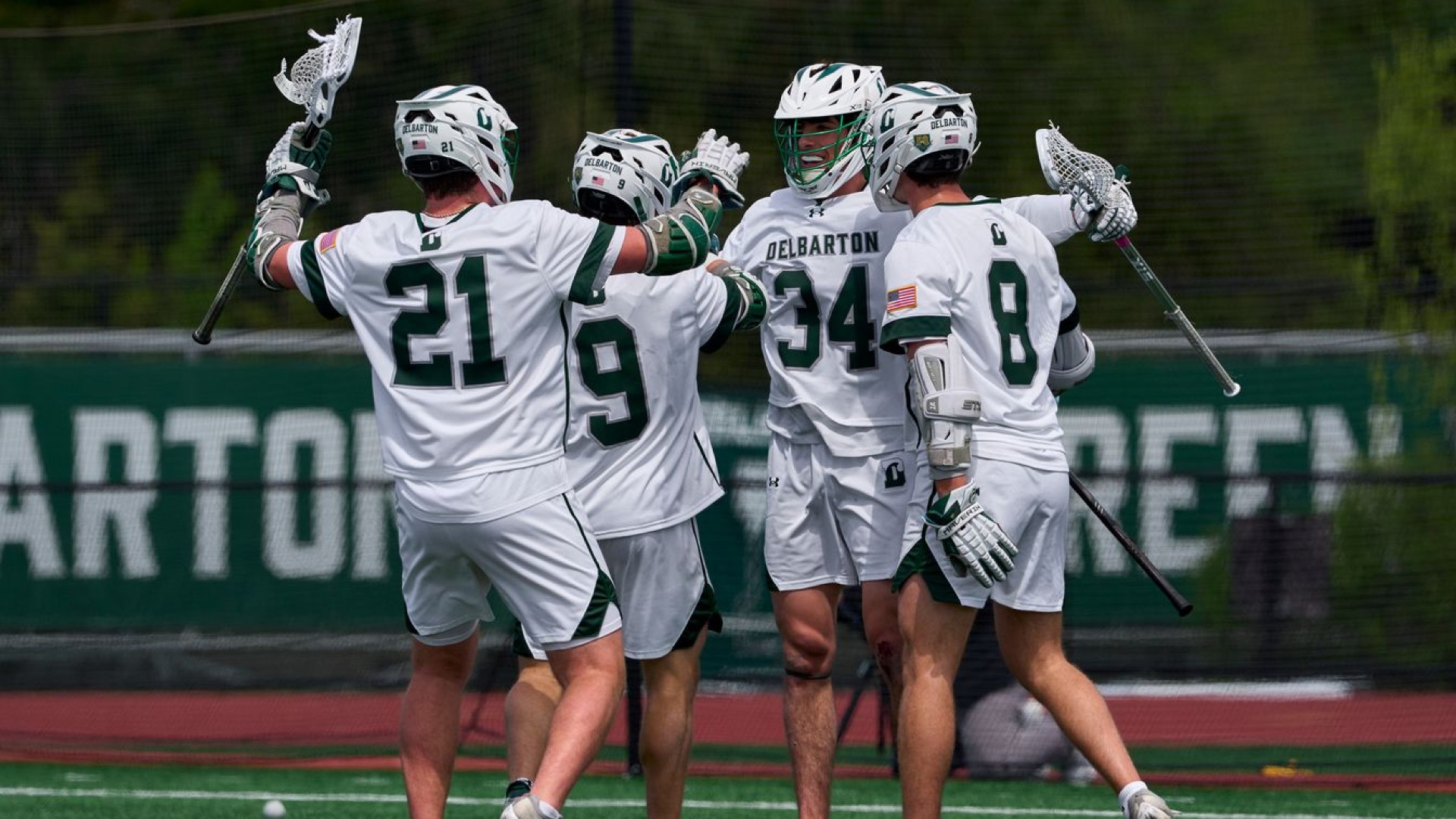 lacrosse team celebrates after a goal