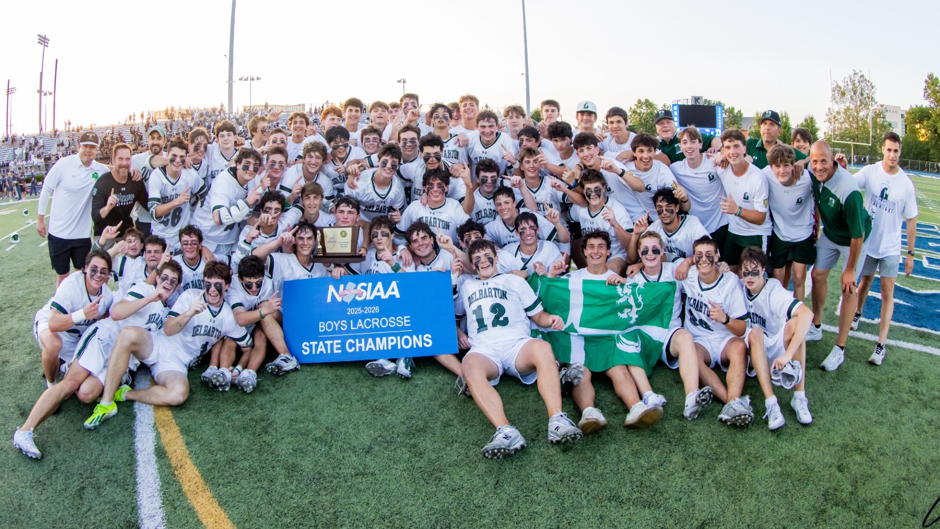 team celebrates in group shot after winning championship with the trophy