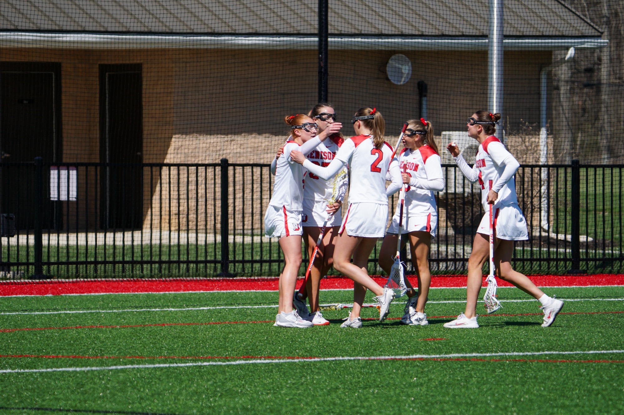 Women's Lax Celebrating Goal