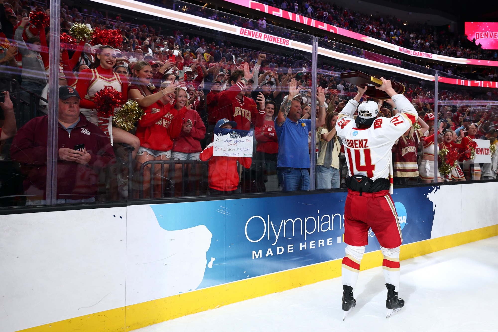LAS VEGAS, NEVADA - APRIL 11: Rieger Lorenz #14 of the Denver Pioneers raises the championshiop trophy in front of fans during the Division I Men's Ice Hockey Championship held at T-Mobile Arena on April 11, 2026 in Las Vegas, Nevada. (Photo by Tyler Schank/NCAA Photos via Getty Images)