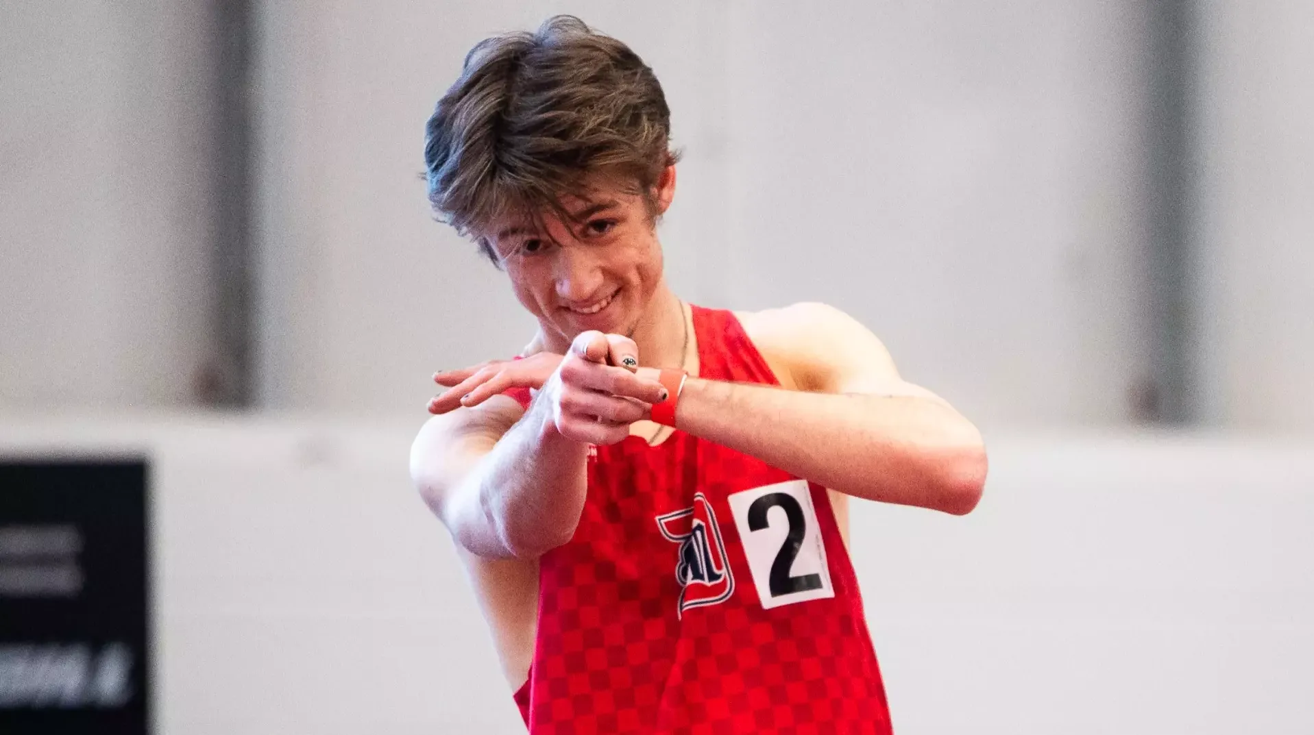 Joshua Otten celebrates his win in the mile 