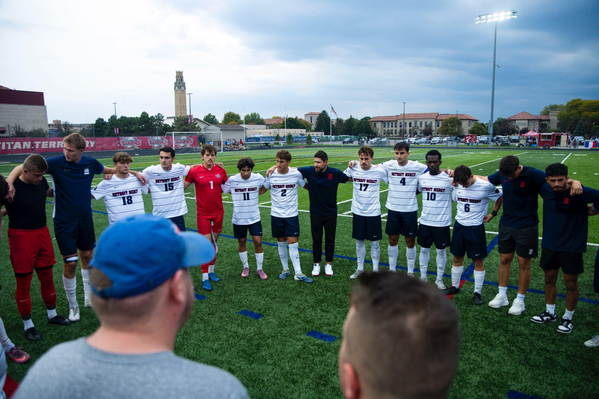 Nate Kopunek, head men's soccer coach, addresses the team ahead of kickoff.