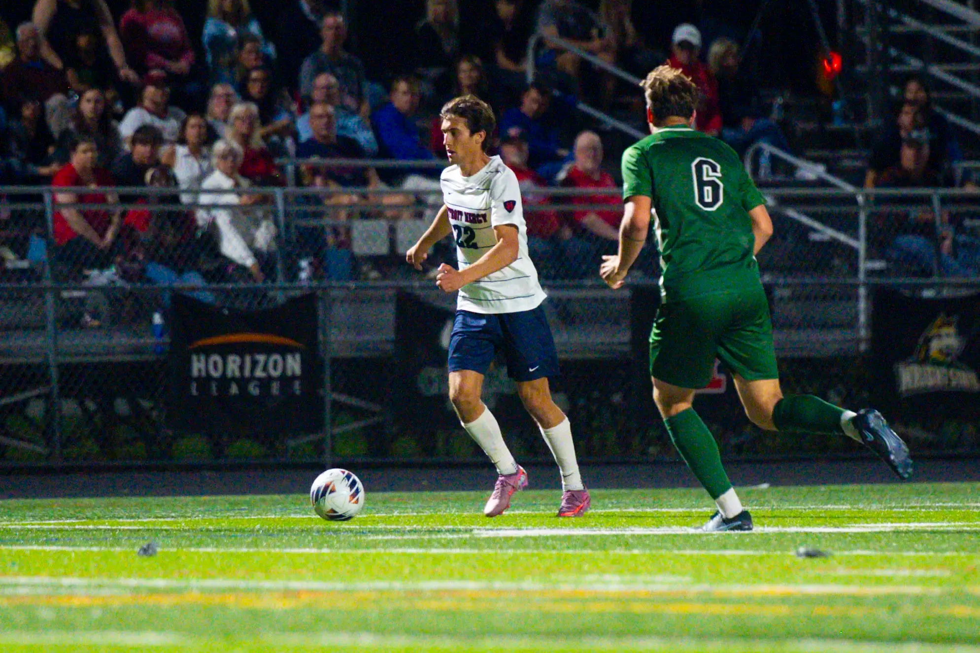 Johnny Strickler, sophomore midfielder, looks to pass.